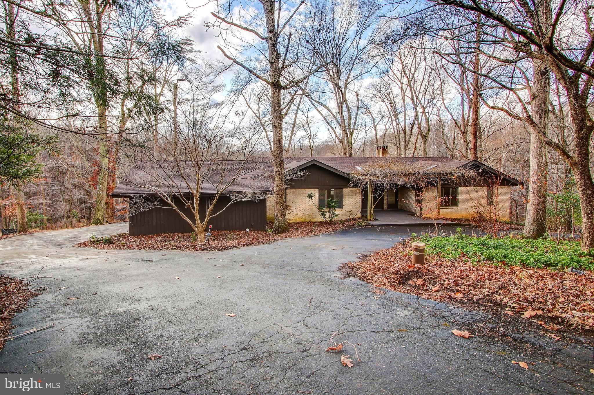 You MUST SEE this Amazing Home! Located in a Private Wooded Oasis, at the End of Cul-De-Sac, this Beautiful Large Custom Built Rambler on 3.9 Acres Backs to Woods that stretch as far as the eye can see - There are Two Streams on the Property!  Walls of Windows provide both an abundance of Light and Amazing Views, and the deck across the entire backside of the house helps maximize the enjoyment of this extraordinary setting. This home is Larger than it looks with over 4,500 Sq/Ft,  5 Bedrooms, 3 Full Baths, a 2 Car Side-load Garage and generous room sizes everywhere. The Level Entry at the Front and Garage make this One Level Living at its Finest!