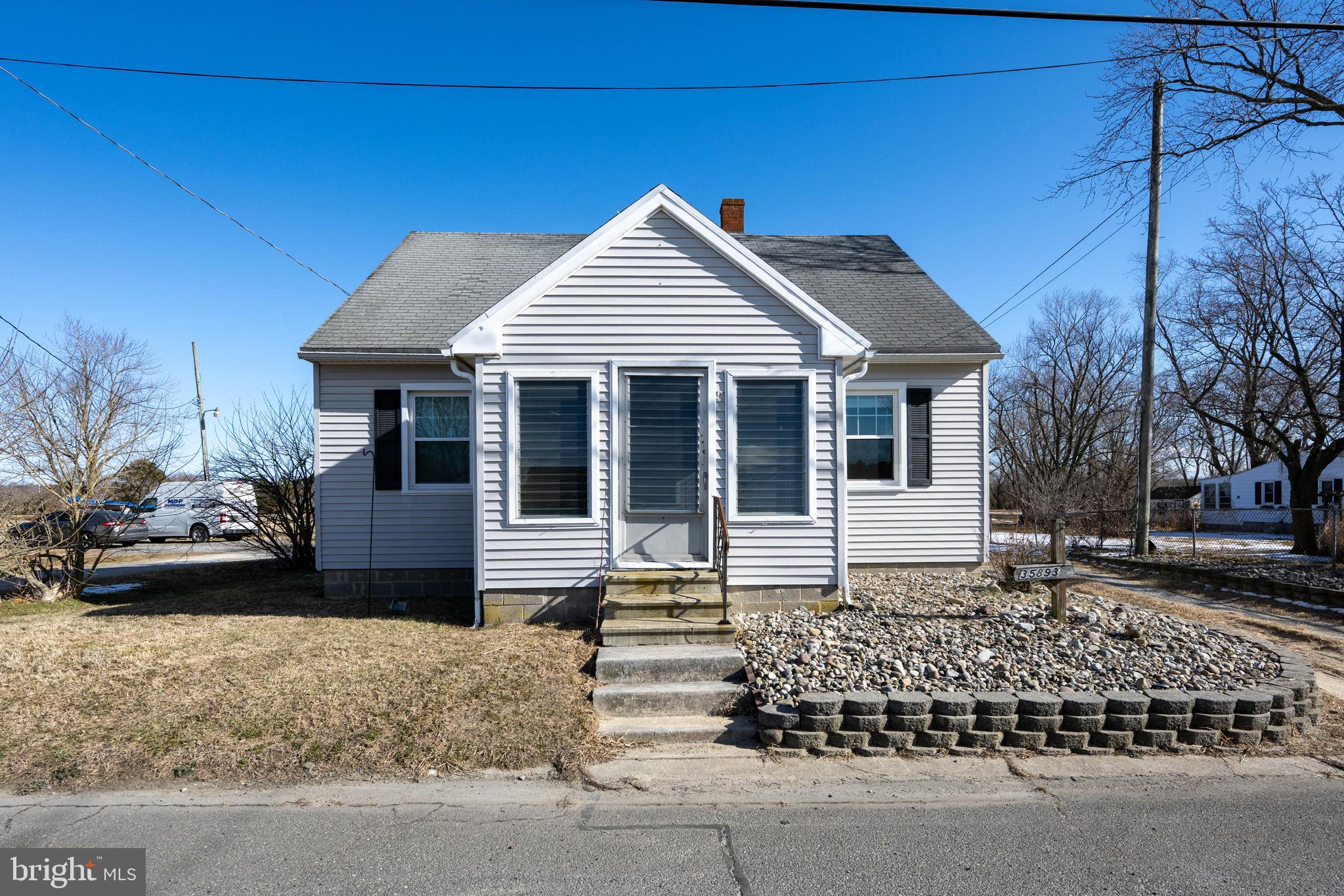 Conveniently located with easy access to all that coastal Delaware has to offer, this 3 bedroom, 2 bath home is just minutes from schools, shopping, Beebe Healthcare, and only 15 minutes to Bethany Beach and Fenwick Island. Recent updates include new windows with a transferable warranty and refreshed bathrooms. The inviting front porch adds charm, while the spacious backyard offers plenty of room to for your boat & beach gear. Original hardwood under the carpets. With no HOA restrictions, this property would make a great primary residence, second home, retirement retreat, or investment opportunity. Home is being sold AS-IS and is ready for new owners to make it their own.