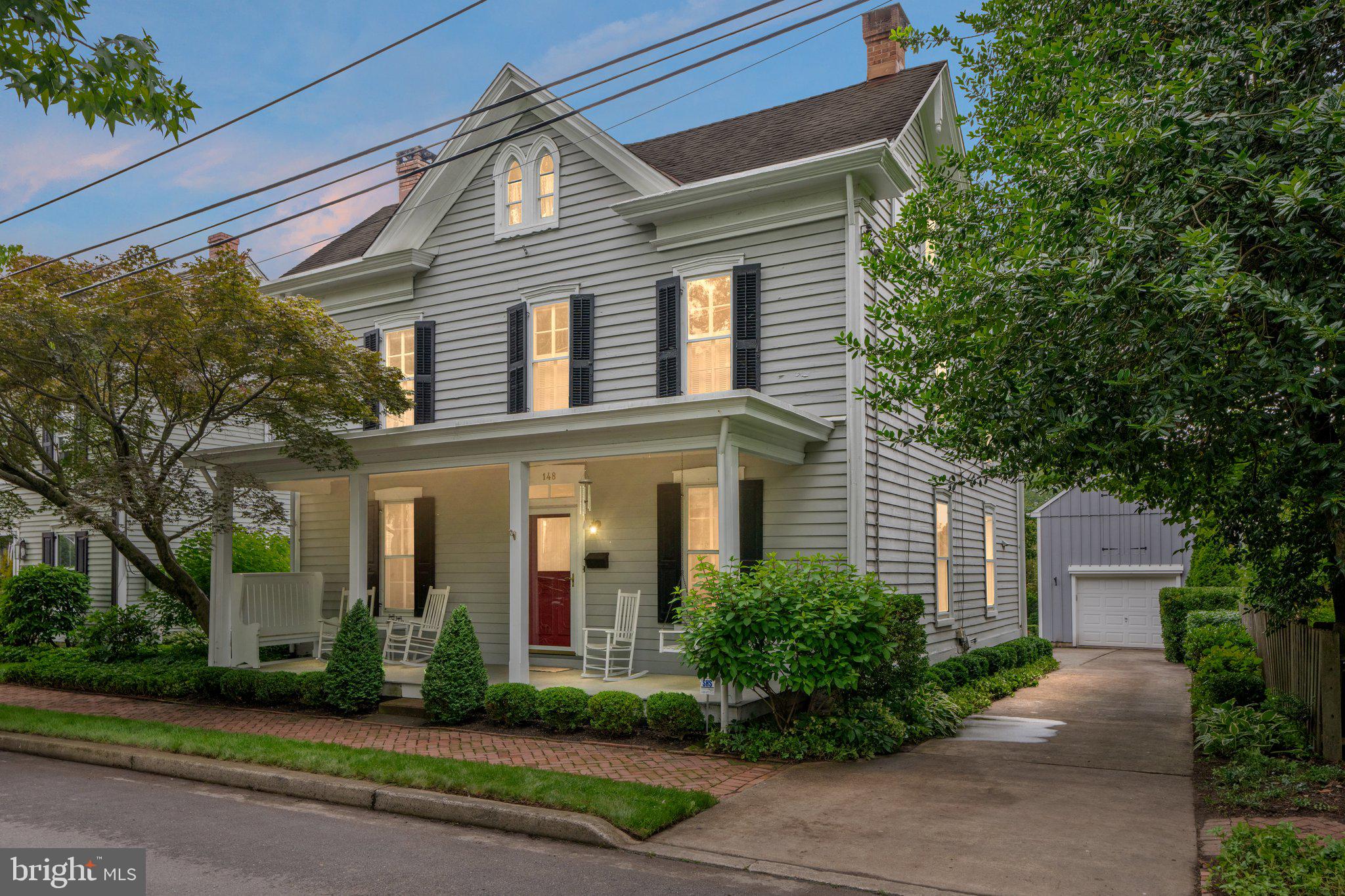 Welcome to 148 Liberty Street - the Joseph Firman House—an exquisite example of Victorian Gothic architecture tucked into one of Newtown Borough’s most historic and picturesque blocks. Built circa 1860 by noted builder and landowner Joseph Firman , this 4-bedroom, 2.5-bath residence offers a rare blend of preserved 19th-century character and thoughtful modern upgrades.

From the double pointed-arch windows and steep gabled roof to the deep eaves and delicate gable pendants, this home is a standout in local architectural history. Inside, you'll find a large living room and dining room, original wide-plank wood floors, charming millwork, and  fireplace. The family room is a wonderful gathering space and flows into a modern kitchen with a large center island, and a bright breakfast room addition overlooking a peaceful brick patio and garden.

The second floor offers three bedrooms including a hall bath and an expanded primary suite, while the third floor provides a versatile retreat—a perfect 4th bedroom and playroom, studio, or bonus guest space. 

Outside, enjoy a beautifully landscaped and very private back yard. The detached garage/barn has a second floor for hobbies, gym space, or storage.

All of this just steps from boutique shopping, award-winning restaurants and pubs, cozy coffee shops, playgrounds, and Tyler State Park. Located in the Council Rock North School District and only minutes from major commuter routes to Philadelphia, New York, and the Princeton Corridor, this home is not just a piece of history—it’s a lifestyle.

Whether it's cozy nights curled up by the fire, a lazy afternoon on the front porch or balmy summer barbeques on the patio, this home offers it all. Welcome to 148 Liberty St... Maybe you are home already!