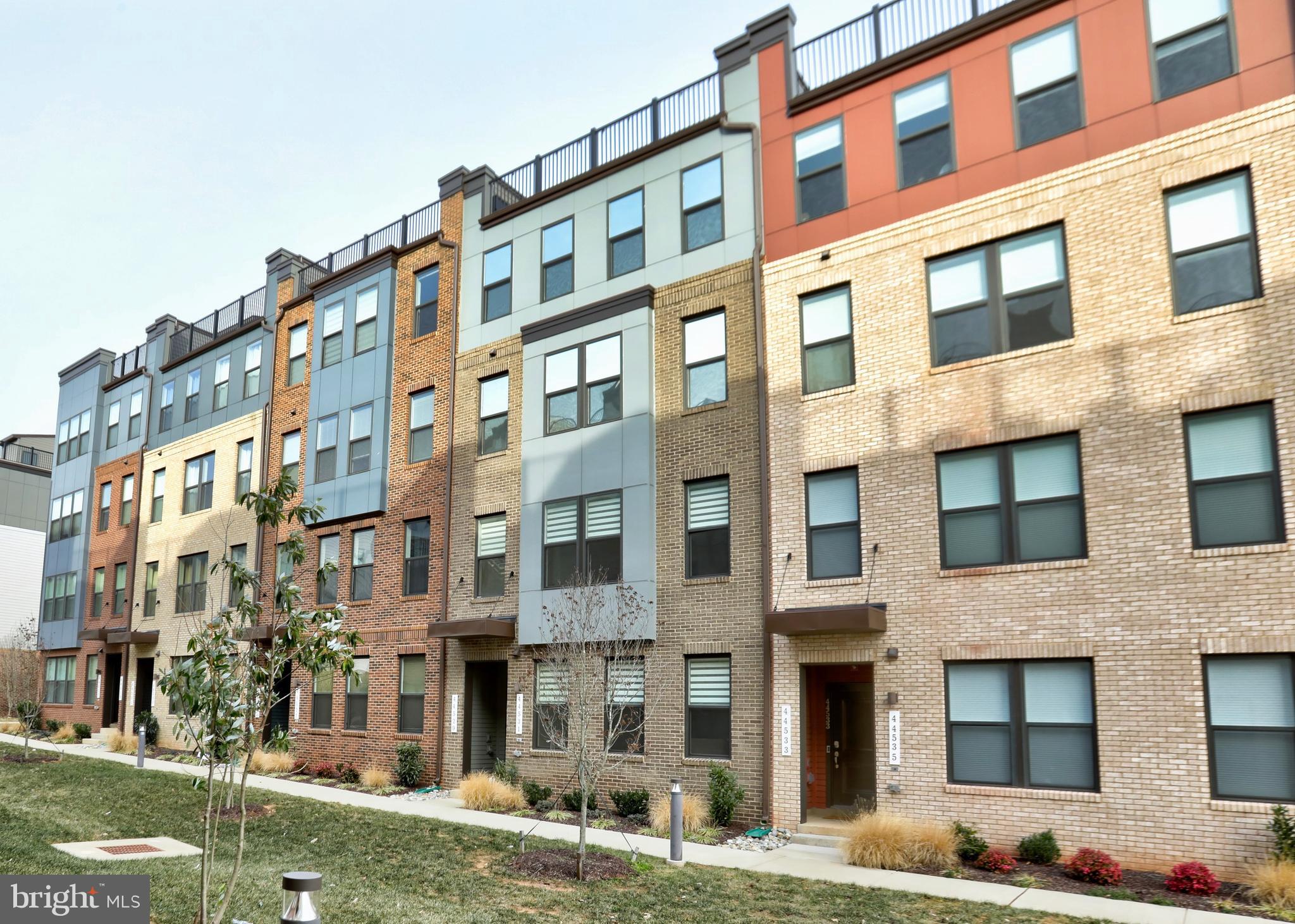 Welcome to 44531 Wolfhound Square, a premium 2-bedroom, 2.5-bath townhome-style condo with an attached one-car garage, offering approximately 1,670 square feet of finished living space in the heart of Ashburn’s One Loudoun community. Less than three years young, this home offers a new-build feel with over $33,000 in high-end upgrades—without the wait—and is located just steps from One Loudoun’s dining, shopping, entertainment, and year-round Saturday farmers market, with convenient access to the Ashburn Metro Station on the Silver Line and Dulles International Airport via a nearby community shuttle stop just outside the Ashbrook entrance. Nearby green space, a community picnic area, and dog park further enhance the neighborhood’s walkable appeal.

The entry level opens into a wide, open main living area anchored by a generously sized living room and a thoughtfully designed kitchen with excellent storage. Luxury vinyl plank flooring runs throughout, complemented by abundant natural light and a layout that feels both expansive and functional. The gourmet kitchen features a high-end Café smart appliance suite, with all appliances fully app-enabled via Wi-Fi—including double wall ovens with precision cooking modes, an induction cooktop for fast, responsive heat, a built-in microwave, a French-door refrigerator with temperature-controlled zones, and an ultra-quiet dishwasher. An MSI Carrara Marmi waterfall-edge quartz island serves as the focal point, paired with Sonoma Boulder soft-close cabinetry, pull-out trash bins, dual pantry closets, and a Maiolica White Gloss backsplash. The main level also includes a convenient entry closet with custom shelving and direct access to the fully finished garage.

The upper level offers true separation of space, beginning with a secondary living area that functions perfectly as a den, office, or lounge — or could easily be converted into a 3rd bedroom — and opens directly to the private outdoor deck, ideal for dining or unwinding at home. The primary bedroom is generously scaled, accommodating a king-size bed with ease, and features a walk-in closet and a spa-inspired ensuite bath with dual quartz vanities and an oversized heavy-glass shower finished with full-height Orchid Atlas tile. A secondary bedroom is well proportioned with its own closet and access to the hall bath. A dedicated upper-level laundry room is centrally located for everyday convenience.  

Additional upgrades include plush Shaw carpeting on the upper level, custom closet systems, Zebra blinds for light control and privacy, smart home wiring with Cat6 and HDMI prewire, pre-wired speakers, a video doorbell, Kichler LED recessed lighting throughout, and a high-efficiency Electrolux washer and dryer. The garage is fully finished and painted, complete with shelving and a Wi-Fi-enabled opener—altogether contributing approximately $4,000 in added value beyond the original $33,000 design package.

* One Loudoun DownTown, 20 min walk (listing the amenities, restaurants, stores etc.)
* Whole Foods Market (2 miles); 
* Ashbrook Plaza: Lidl, Harris Teeter, Planet Fitness, OneLife, gas stations (1 mile)
* One Loudoun Park, 5 min walk
* HOA: Picnic area and dog park
* Saturday Farmers market, 3 min walk, all year round.
* Commuting (let's reduce this detailed info to a few lines) - bus station, a 5 minutes walk.
      - Route 331 (One Loudoun/Ashburn Metro Station): Operates weekdays between the Ashburn
      - Metrorail Station and the One Loudoun Park & Ride
      - Route 332 (Potomac Green/One Loudoun): Provides weekday service from Ashburn Metro Station to several stops in One Loudoun, including Exchange & Brimfield and the One Loudoun Park & Ride.
      - Route 62 (Ashburn Connector): Offers local service connecting Ashburn Village and Dulles Town Center to One Loudoun. The most convenient stop for this route is at the One Loudoun - Exchange Street Shelter.
