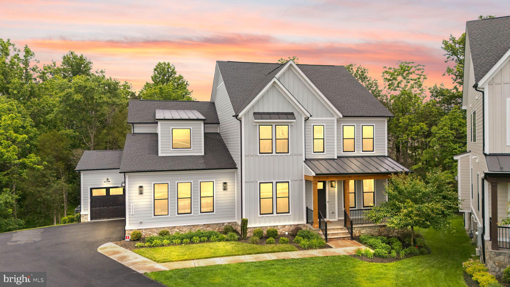 This stunning residence BACKS TO RARE TREED PRIVACY on a PREMIUM 0.43 ACRE CUL DE SAC HOMESITE in the sought-after community of HARTLAND. With over 5,600 finished square feet across three beautifully designed levels, this MULTIGENERATIONAL residence offers SIX spacious bedrooms (one BEDROOM ON THE MAIN LEVEL), 6 full bathrooms, 1 half bathroom, and a 3-CAR GARAGE thoughtfully prepared with an EV charging hookup. All three levels were extended at time of construction just three years ago, filled with natural light and enhanced by soaring 10-foot ceilings, creating luxury, comfort, and modern convenience. And just wait until you see the SCREENED PORCH!

The main level is designed for both grand entertaining and comfortable everyday living, featuring a desirable main-level bedroom with private full bath, a lovely office with custom built-in bookshelves, and a stunning chef’s kitchen with quartz countertops, designer backsplash, white and grey cabinetry, walk-in pantry, and expansive gathering spaces. Enjoy birdsong from a screened porch overlooking the beautifully treed backyard that provides exceptional privacy and a peaceful natural setting. 

Upstairs, the luxurious primary suite serves as a peaceful retreat with a coffered ceiling, spacious sitting area, dual walk-in closets, and a spa-inspired bathroom featuring dual vanities, an oversized shower with built-in seating, and an elegant freestanding soaking tub. Additional upper-level bedrooms are generously sized and prewired for wall-mounted TVs. An upstairs laundry room with a sink adds everyday convenience.

The WALK-OUT LOWER LEVEL offers incredible flexibility with a large club room, captivating WET BAR for entertaining or a fun movie night, an ADDITIONAL BEDROOM, plus two full bathrooms—ideal for guests, multi-generational living, guests, or extended stays. Along with the extensive spaces finished on this level, there is also plentiful storage space. 

Located in the amenity-rich Hartland community, residents enjoy access to resort-style amenities including a clubhouse with state-of-the-art fitness center, great room, playroom and locker rooms, as well as a competition sized pool, playground, plus tennis, basketball, and pickle ball courts. One of the walking trails leads to the historic, 35 acre Old Farm Winery!  Plentiful shopping, dining, top-rated Loudoun County schools, and Washington Dulles International Airport are nearby. Experience the comfort and peace of mind that come with owning a newer luxury home.

Some of the many improvements the homeowners put into this home: 3-level extension, matte black metal roof accent, black windows, flagstone patio and walkway, stone water table, linear fireplace in the great room, executive wet bar in lower level rec room, ceiling junctions for future chandeliers and ceiling fans, recessed lighting, stylish window treatments throughout the home, built-in bookshelves in the office, sprinkler system in the front yard. It's all in the details, and these original homeowners display pride of ownership. Schedule your showing today!