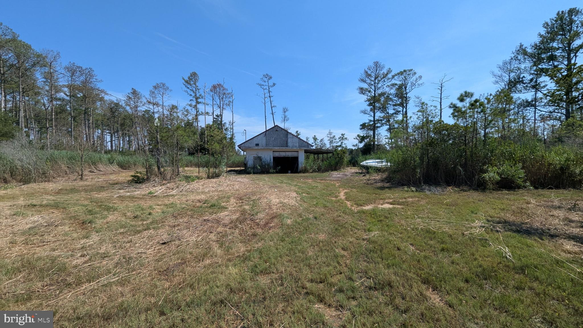 This private 3.06-acre property offers a fantastic opportunity for your future home or retreat. The lot features existing electric service, a well, and septic system already in place. A detached garage with a concrete floor and two overhead doors provides great storage or workshop potential. There’s also a currently uninhabitable mobile home with an addition on a concrete slab. Abundant wildlife, including deer, frequently visit the property, enhancing its peaceful, secluded setting. The lane is gated with a lock on the chain for added security. Whether you’re looking to renovate or build new, this spacious lot offers the ideal foundation for your vision.