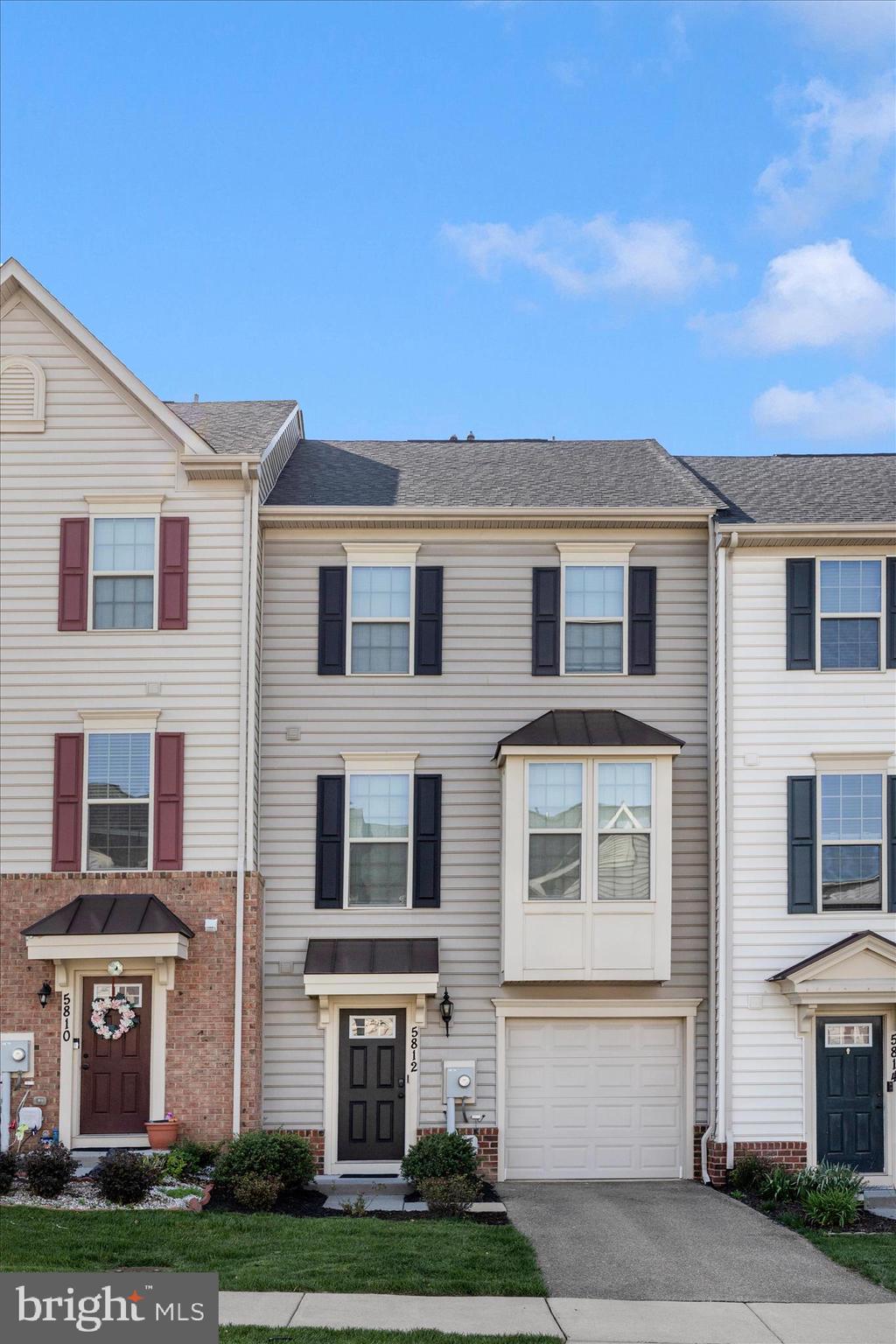 Welcome home to this stunning four-level garage townhome in the highly sought-after Oakdale Village community!

Designed for both comfortable everyday living and effortless entertaining, this spacious home offers an exceptional layout across four finished levels. The entry level features a large family room with direct access to the backyard, along with a convenient powder room.

Upstairs, the open-concept main level is the heart of the home. The beautifully appointed kitchen boasts a massive center island, abundant cabinetry, and plenty of space for gathering with family and friends. The expansive floor plan includes a formal living area, dining space, and an additional sitting or family room, as well as a second powder room. Step outside to the oversized deck—perfect for outdoor dining, relaxing, or entertaining.

The bedroom level offers a spacious primary suite complete with a private bath, along with two generously sized secondary bedrooms that share a full hall bathroom. A dedicated laundry room with extra storage and a convenient linen closet add to the home's functionality.

The impressive fourth level provides incredible flexibility with a large bonus room that can serve as a fourth bedroom, home office, recreation room, or guest suite. This level also features a third full bathroom and access to a spectacular rooftop terrace—the perfect place to unwind and enjoy the outdoors.

Ideally located within walking distance of schools, playgrounds, grocery stores, shopping, and dining, this home is also served by the highly acclaimed Oakdale Elementary, Middle, and High Schools. With space, style, convenience, and an unbeatable location, this home truly checks every box.