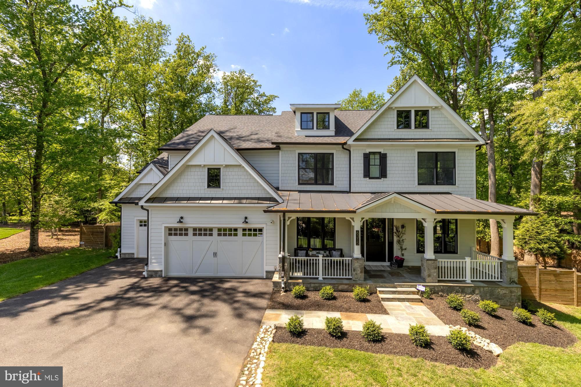 Welcome to bespoke luxury! Tucked at the end of a private pipestem on a beautifully landscaped, flat ¾-acre lot, this exceptional 2022 custom residence by Mid-Atlantic Custom Builders offers over 7,400 square feet, 7 bedrooms, 7 full baths, 2 powder rooms, and a three-car garage—with the rare opportunity for nearly $400,000 in curated, designer furnishings to convey, creating a truly turnkey luxury experience.

Located in the coveted Luxmanor community, the home is zoned for top-tier Montgomery County schools and delivers the perfect blend of privacy, sophistication, and everyday livability. From the grand foyer with herringbone white oak flooring to the seamless indoor-outdoor flow, every detail has been thoughtfully designed for both elegant entertaining and welcoming family life.

The heart of the home is a stunning Stuart Kitchens designer chef’s kitchen featuring dual islands, quartz countertops, custom cabinetry, and premium appliances including a Wolf range, Sub-Zero refrigeration, and dual Asko dishwashers. The adjoining family room, screened porch with fireplace, and deck overlook the expansive, level backyard—ideal for gatherings, play, or future outdoor enhancements.

A main-level guest suite, private study with fireplace, and custom mudroom enhance functionality, while the upper levels offer a luxurious primary retreat with terrace, coffee bar, dual walk-in closets, and spa bath, plus multiple en-suite bedrooms and flexible living spaces. The loft level with open terrace and the walk-up lower level—complete with wet bar, wine wall, gym/media room, and guest suite—provide exceptional versatility.

Moments from Pike & Rose, Bethesda, and major commuter routes, yet quietly set apart, this is a rare opportunity to own a private, design-forward estate in one of Rockville’s most sought-after neighborhoods—where luxury and comfort come together effortlessly.
