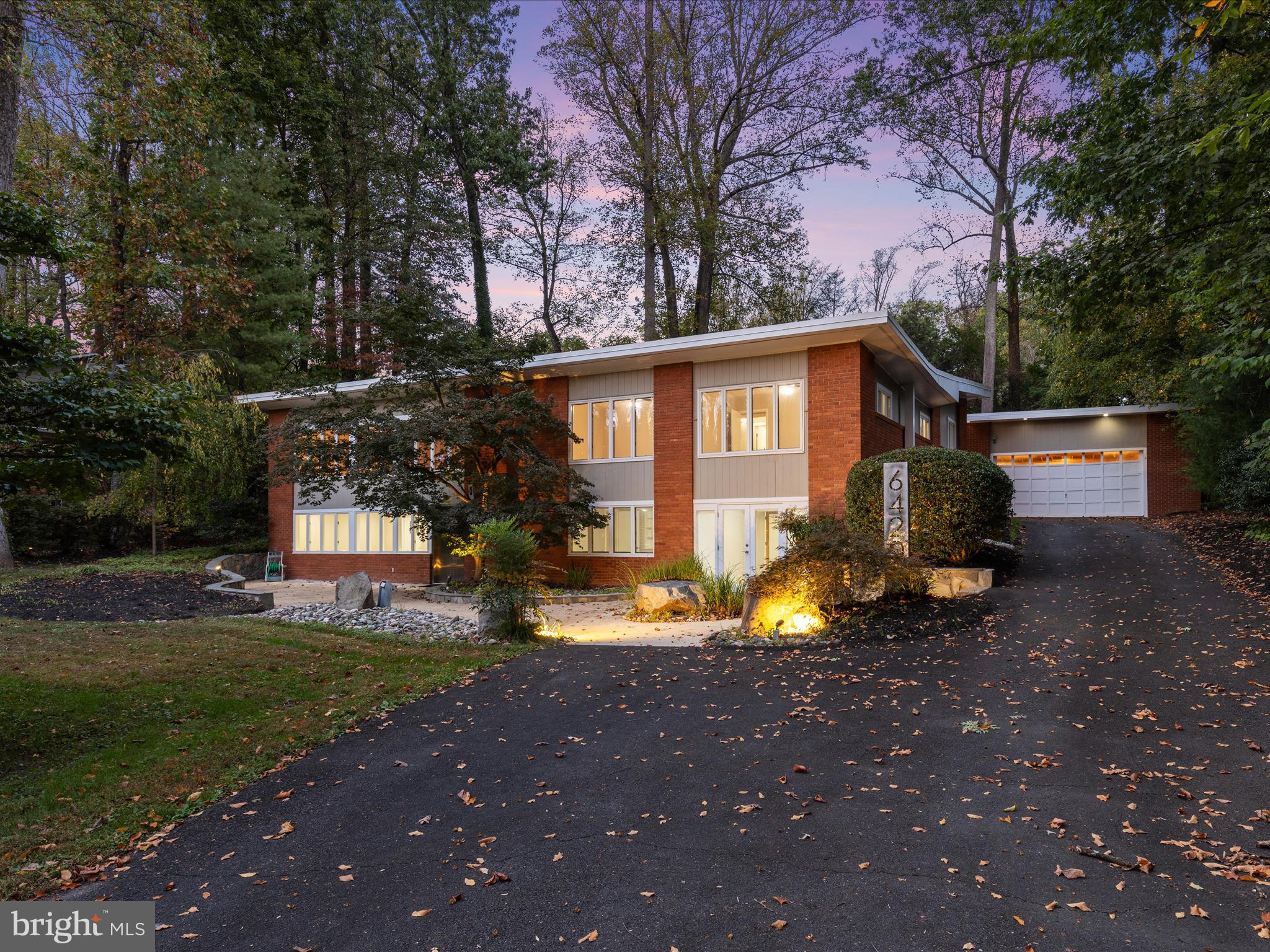 Welcome to this serene, half acre mid-century modern, open concept property in the amenity-rich Lake Barcroft community (5 mins walk to one of 5 private beaches)! This 6 bedroom / 4.5 bathroom property includes a massive rear addition that added the EPDM 50-year rubber roof (2005) as well as curated outdoor living + walls of windows for tons of natural light. Don't miss the rear terrace with an oversized wood-burning fireplace and built-in gas grill.  The private, mature flowering gardens surround the property and huge lush backyard. A detached 2-car garage offers a versatile, unique separate space for cars, work shops, home gyms, etc.  Newer HVAC Replacements: Lower Unit (2024) and Upper Unit (2022). Whole House Generator included.

Inside there are multiple living areas including a grandiose Kitchen complete with Neff Custom Euro-Laminate Maple Cabinetry, Jenn-Air Fridge, and industrial gas range. The rest of the main living areas includes hardwood floors, a spacious Family Room w/ gas fireplace & a Great Room off the Kitchen with cathedral ceilings, wall of windows, and hickory wood custom built-in cabinetry. The gourmet Kitchen with center island is the heartbeat of the home w/ a unique Butlers Kitchen offering a 2nd fridge, sink and dishwasher + additional counters and storage. There are private entrances on two levels, with the Primary Suite featuring a huge walk-in closet with custom built-ins. The renovated primary ensuite bathroom features a steam shower, jacuzzi tub, and dual sinks along with high-end tile work.  The bedrooms are split with 3 on the main living level and 3 on the lower-living level that also walks out to grade - each with their own laundry facilities and full bathrooms. The lower-level living area includes its own living areas with polished concrete flooring, spaces for guests, and multiple home offices as well as 2 entrances to the outdoors. The step down basement adds one more Rec Room area for open concept living and has access to additional storage rooms.

Located within the Lake Barcroft community, access to 5 private beaches is included along with fishing, boating, playground all available for residents only. Washington D.C. is only 6 miles away while enjoying living among the trees and nature preserve.