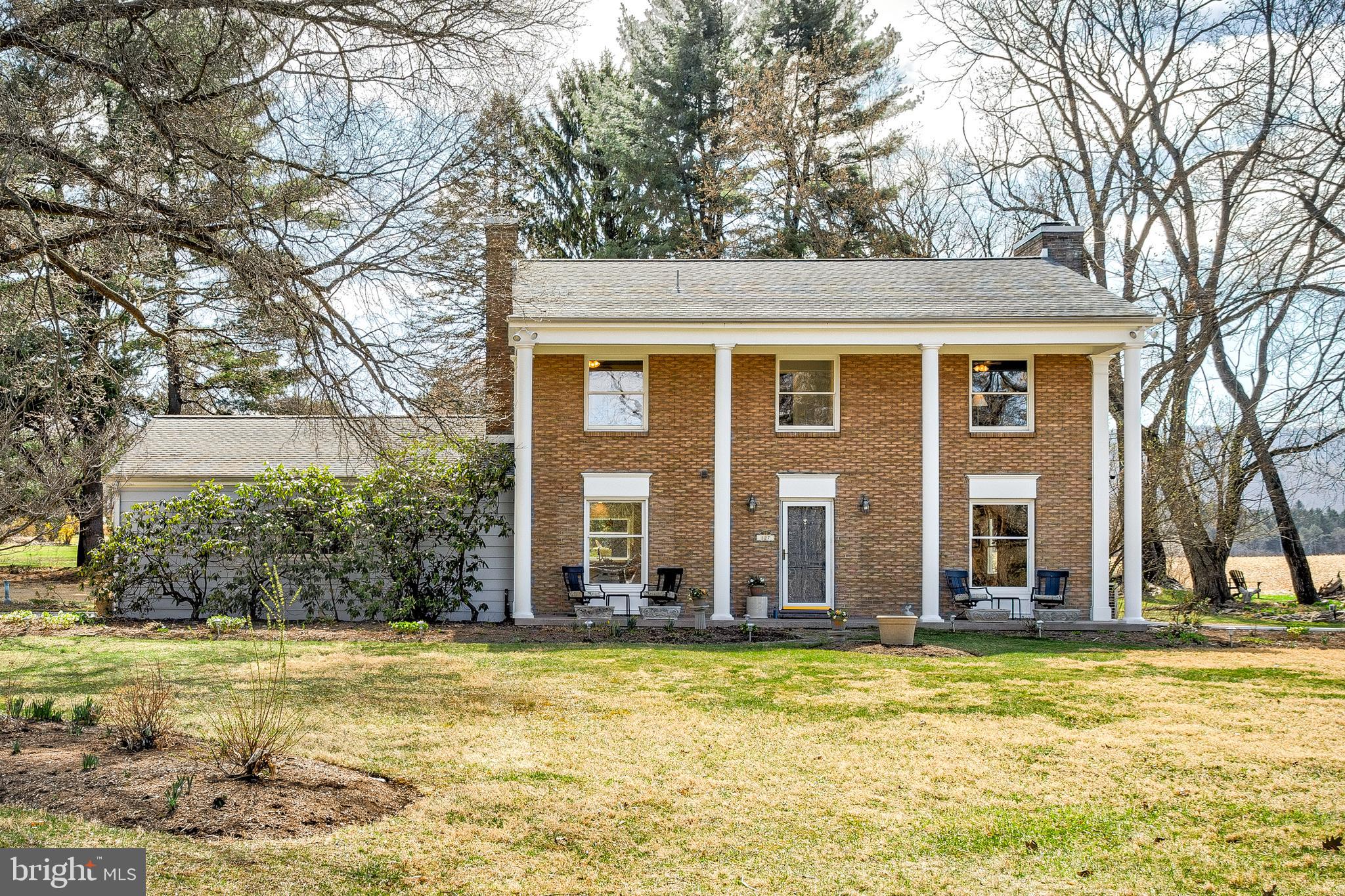 Welcome Home to this gorgeous, remodeled home in the coveted Harris Acres Neighborhood. Offering a perfect blend of modern updates and serene country charm, this four-bedroom, two-and-a-half-bath 2-story home is situated on a picture-perfect .93-acre lot that borders farm fields and features amazing panoramic views. As you step inside the slate entry, you will immediately appreciate the new open-concept main level, which combines luxury with everyday needs and provides a fantastic new space for entertaining. The brand-new kitchen boasts sleek finishes and is entirely open to the new family room, featuring a propane stone fireplace and lighted, custom-built-in cabinets. It flows seamlessly into the spacious living and dining room areas. All bathrooms have been remodeled to add a fresh and stylish touch to this home. Both the main level and 2nd floor have gorgeous hardwood flooring throughout, except for the kitchen and bathrooms, which feature tile flooring. Additional highlights include a wonderful screened-in porch to enjoy the abundance of wildlife, a professionally landscaped yard with mature trees, flowers, and a huge garden to grow everything from garlic to berries and vegetables. It has an oversized 2- car garage, central air for year-round comfort, and a prime location in State College Area School District on the end of a cul de sac, ensuring both privacy and convenience to downtown State College and Penn State University.