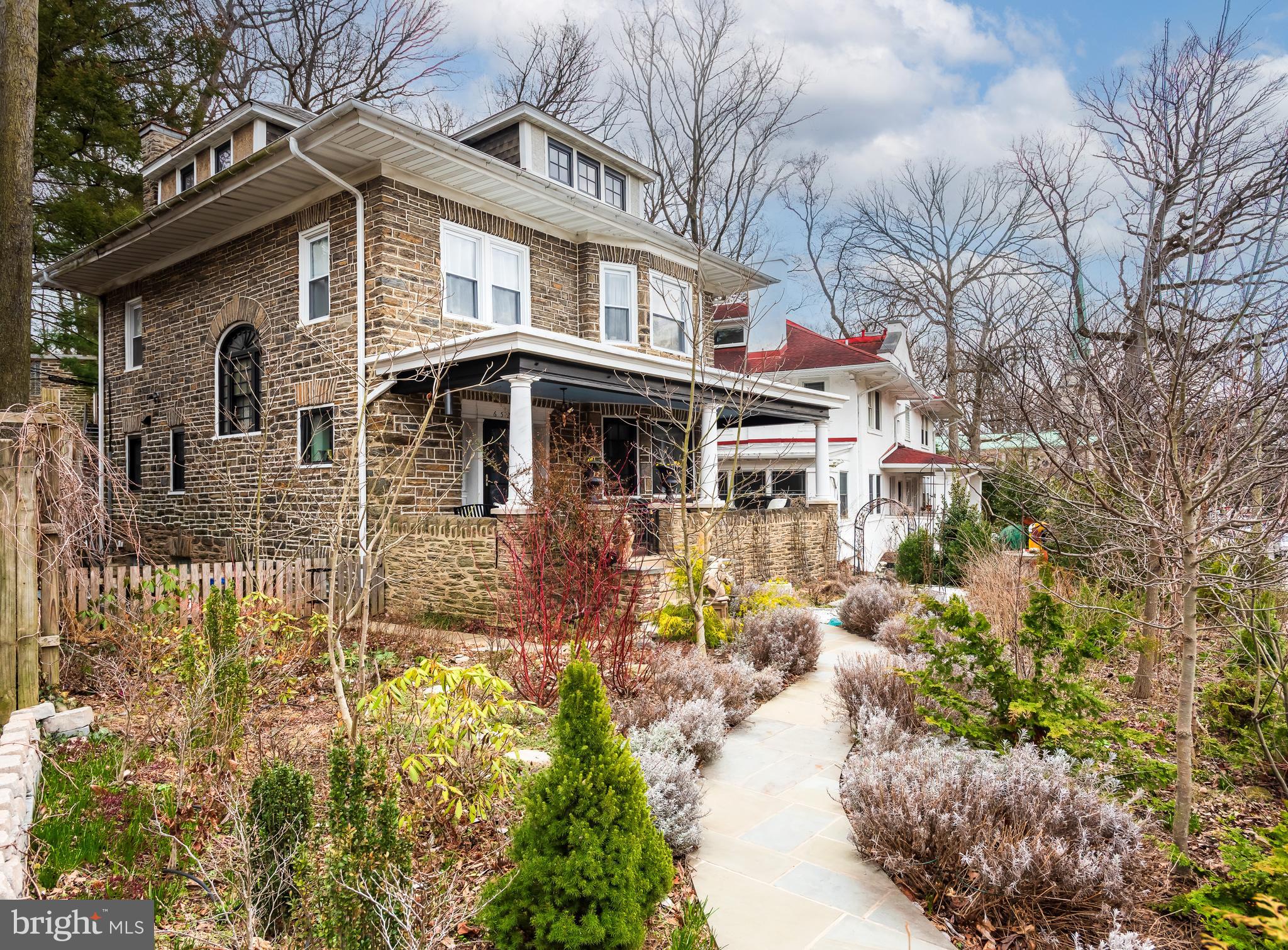 Built in 1925, this classic stone colonial in West Mount Airy seamlessly blends timeless architectural details with contemporary comforts. This meticulously maintained home features five bedrooms, two full baths, and two half baths, and provides a rare opportunity to own a detached single-family home on Lincoln Drive .As you approach the home on the flagstone walkway, you pass specimen trees and flowering perennials, and find a large front porch that invites you into the residence. Every detail of this property has been lovingly restored, and we look forward to finding new owners to take stewardship of this stunning home.The spacious living room has bright windows that fill the room with sunlight and features original mahogany inlaid hardwood floors found throughout the house. A stone-framed gas fireplace with wood mantle stands proudly in the room. Original wood moldings and a built-in wall niche remind you of a bygone era. The large dining room with its original pocket door, flows from the living room and is filled with windows and sunlight overlooking the gardens.The gorgeous new kitchen is a chef's delight. It features bespoke tiling work, heated floors, tons of storage and counter space for all of your cooking and baking needs, Bosch appliances, a 6-burner gas cooktop, a double oven, leather-finish granite countertops, and a farm sink. In keeping with the home's era, the kitchen cabinet color reflects the home's original style. From the kitchen you exit to the peaceful fenced-in backyard filled with charming trees framing lush flower beds, two raised herb gardens, a relaxing fire pit, and a lovely slate stone patio with plenty of room for outdoor entertaining and dining.As you meander through the home, you will find a charming powder room on the first floor with original accents. A stately palladium window graces the central staircase. An additional powder room on the second floor is highlighted by a pressed copper ceiling.The primary bedroom suite is drenched in sunlight and includes an attached walk-in dressing room with custom cabinetry throughout. The en-suite bath showcases stunning glass tile, a stone accent wall, heated slate floors and bench, a soaking tub, and double vanity. A great room also anchors this floor and currently provides an entertainment space and library. This grand room is filled with windows, light, and endless possibilities for future owners.The third floor boasts 3 additional rooms each with an ample walk-in closet – currently a full-sized laundry room, a guest bedroom and a home office -- as well as a second full bathroom.From the backyard, you can access a detached stone garage that provides additional storage and architectural beauty to the property. This outbuilding could easily be converted to a studio or workshop space. The full unfinished basement is also accessible from the yard. It is clean and dry and allows ample access to all the home’s updated infrastructure. Extensive native and pollinator gardens, central air conditioning, and radiant gas heat are additional benefits to this home. 6521 Lincoln Drive is located within easy walking distance of the train and all that Mount Airy and Chestnut Hill offer, along with the beautiful trails and the running paths of the Wissahickon Valley. With comprehensive modern upgrades, beautifully curated outdoor spaces, and an unparalleled historic setting, this home offers a rare blend of comfort, character, and convenience. It is truly move-in ready, and designed for long-term enjoyment. This home should not be missed.
