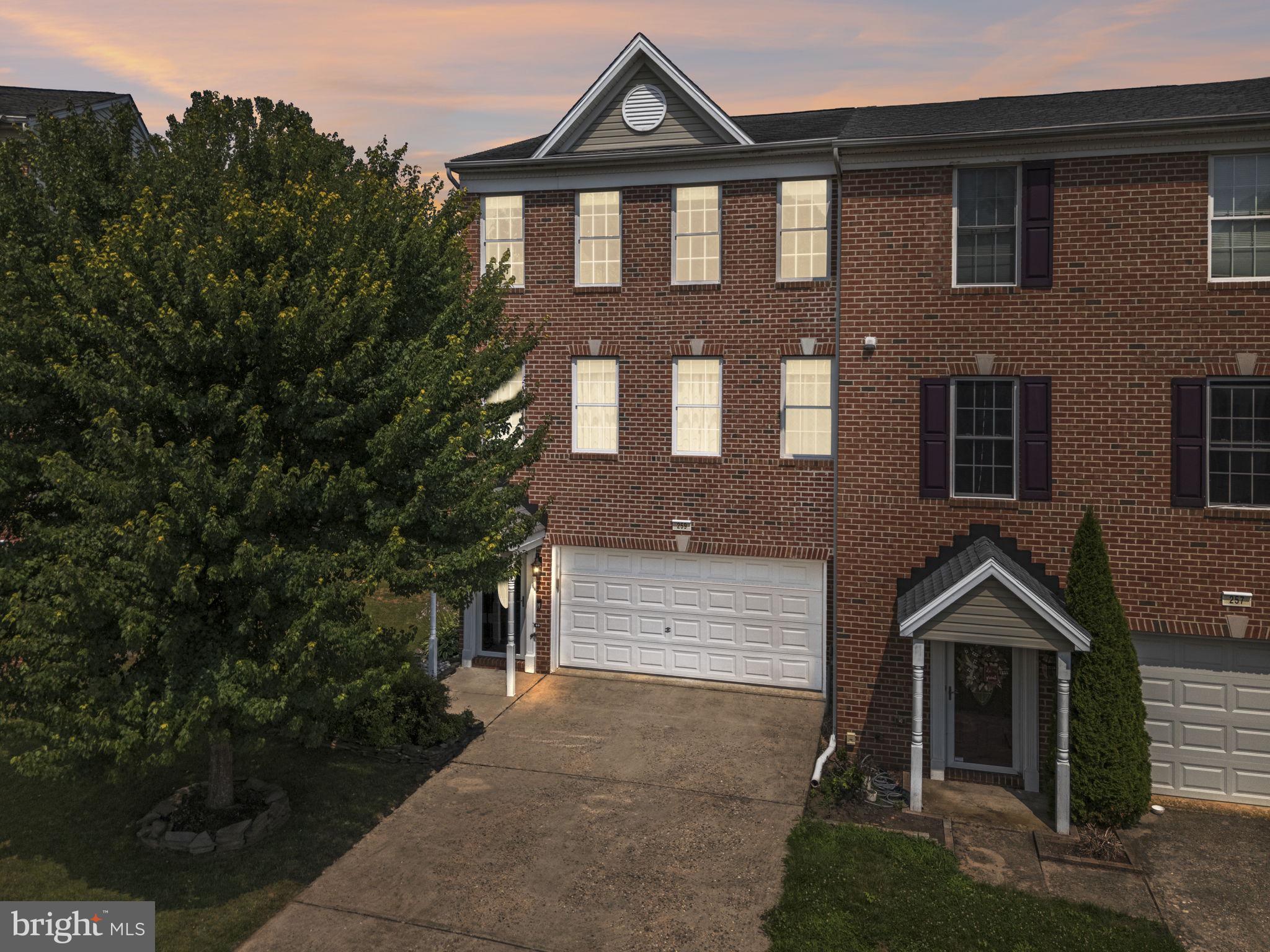 Welcome to 259 N Front Street in New Freedom, an impressive end-of-group townhome offering three bedrooms, two full baths, two half baths, and more than 2,400 square feet of beautifully finished living space across three levels. The main level is filled with natural light and features beautiful flooring, crown molding, decorative columns, and spacious living and dining areas. The well-appointed kitchen offers abundant cabinet space, granite countertops, a mosaic tile backsplash, gas cooking, and a distinctive breakfast bar accented with decorative tin paneling. A stylish powder room with beadboard wainscoting adds even more character. Also on the main level is an inviting den anchored by a dramatic floor-to-ceiling stone fireplace. Upstairs, the spacious primary suite features vaulted ceilings, two walk-in closets, and a private en-suite bath with a double vanity, large soaking tub, and walk-in shower. Two additional bedrooms and a full hall bath complete the upper level, along with conveniently located laundry that keeps everything right where the clothes live. Outside, two generous decks provide wonderful spaces to relax or entertain while overlooking a peaceful wooded backdrop, the historic Northern Central Railway, and the Heritage Rail Trail. An attached two-car garage, concrete driveway, and ample guest parking complete this exceptional, move-in-ready home.