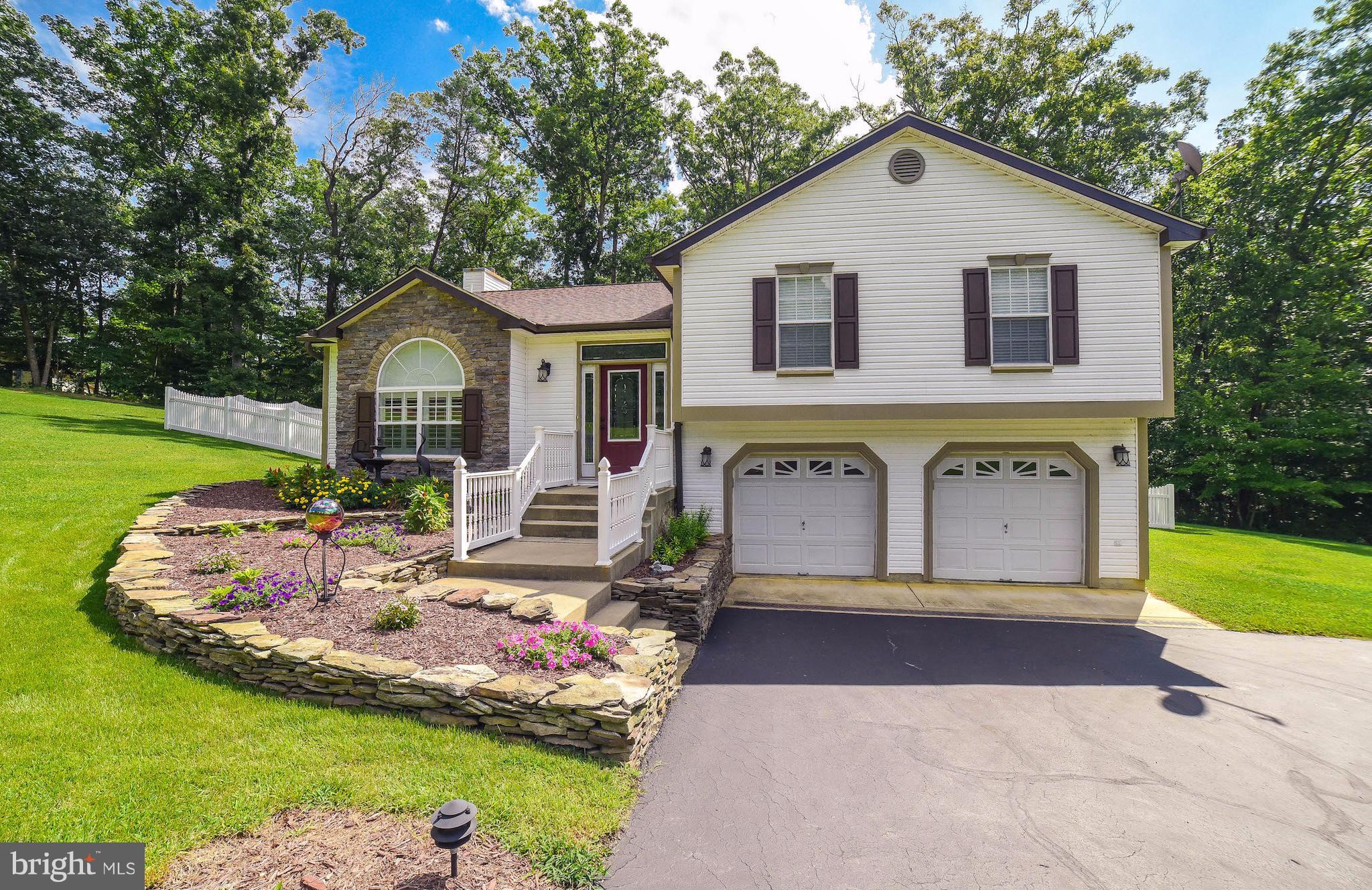 Wonderful split level featuring 4 bedrooms 3 full baths, hardwoods throughout, ceramic tile in kitchen and baths. Large kitchen w island, granite counters, farmhouse sink, ss appliances, doors leading to large deck. Three bdrms 2 bths on main, lower level with additional bdrm, full bath, family room, gas FRPL, slider to patio, and fully fenced backyard, shed and 2.27 acres of privacy!!