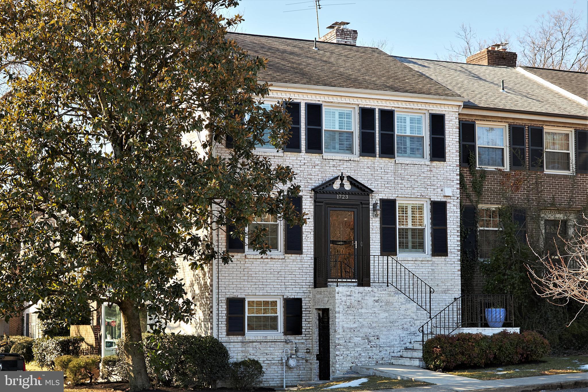 Contracts, if any, need to be in hand by 10:00 am on Wednesday, March 10.   This striking 3-bedroom plus den end townhome with its above grade lower level game room and solarium presides over an 8000+ sqft corner lot distinguished by a magnificent magnolia tree, and brick-enclosed patio with planting beds.  You'll find sparkling updates, 3-sides of windows, 2 fireplaces and large rooms plus a huge kitchen with cork flooring and gas cooking, 3.5 lovely baths -- all in move-in perfection.  Sellers have replaced roof (2008) as well as all appliances, HVAC and windows.   The townhomes of Olde Belhaven Towne are part of a civic association and not a Homeowners' Association  with only a $575/year civic association membership which covers landscaping, snow removal and lighting.    There are 4-5 deeded parking spaces in front and slightly around the front of the home — see the plat online and on the brochure.  In fact, owners of 1723 can enclose the whole side yard, if they want, or paint the house with polka dots (who would?)