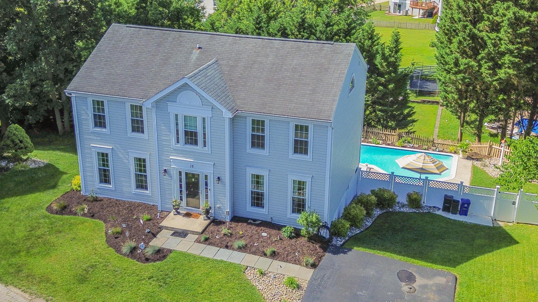 Welcome to this exceptional 4-bedroom, 3.5-bath Colonial offering three fully finished levels of living space and a layout designed for both everyday comfort and effortless indoor/ outdoor entertaining.

Step inside through the welcoming ceramic tile foyer, where you'll immediately appreciate the home's timeless design and attention to detail. To either side of the foyer, formal living and dining rooms showcase gleaming hardwood flooring and elegant crown molding, while the dining room is further enhanced with classic chair rail accents, creating the perfect backdrop for holiday gatherings and special occasions.

Continue into the heart of the home where the gourmet eat-in kitchen awaits. Thoughtfully designed for the home chef, this space features granite countertops, a stylish glass tile backsplash, recessed lighting, stainless steel appliances, a pantry, and a dedicated coffee station. The kitchen opens seamlessly to the spacious family room, highlighted by hardwood flooring, crown molding, and a cozy fireplace, creating an inviting space for relaxing or entertaining. A conveniently located powder room and main-level laundry closet add to the home's functionality and everyday convenience.

The upper level offers four generously sized bedrooms, including a luxurious primary suite designed as a private retreat. Cathedral ceilings create an airy feel, while LVP flooring, a walk-in closet, and a beautifully appointed en-suite bath elevate the space. The primary bath features dual granite vanities, a soaking tub, a ceramic tile walk-in shower, and the added luxury of heated flooring. Three additional bedrooms and a well-appointed full bath complete the upper level.

The fully finished lower level expands your living space significantly and offers incredible versatility. Featuring durable LVP flooring throughout, this level includes a spacious recreation room, a convenient kitchenette complete with a beverage cooler, range, and hood, a private office or potential fifth bedroom, a full bathroom with heated flooring, and abundant storage space. Whether utilized for guests, multigenerational living, a home business, or entertaining, this level provides endless possibilities.

Step outside and discover your own private backyard retreat. Designed with entertaining in mind, the outdoor living spaces are truly remarkable. A covered upper deck with a vaulted ceiling and ceiling fan overlooks the backyard and flows seamlessly onto an expansive composite deck. The centerpiece of the outdoor oasis is the impressive in-ground concrete pool, recently replastered and ready for years of enjoyment. Additional outdoor amenities include a covered rear patio and a private secondary deck tucked away at the rear of the property, creating multiple spaces to relax, dine, and enjoy the outdoors.

Additional updates include the HVAC system, replacement windows, kitchen appliances, pool improvements, and more. Combining spacious interior living, thoughtful upgrades, and resort-style outdoor amenities, this exceptional home offers a rare opportunity to enjoy the very best of indoor and outdoor living. Conveniently located near dining, shopping, goods and services, and major commuter routes.
