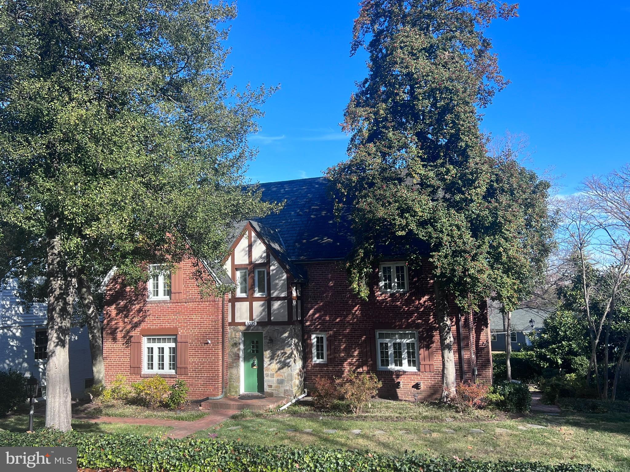 Stately Stone & Brick Tudor in Upscale Aurora Hills Fully Finished 3 Levels of 3400 Square Feet. Well Maintained and Professionally Managed 4 Bedroom 4 Bath Colonial with Attached Garage. Three Levels of Living. Two Primary Suites: 1st Primary Suite is on Main Level and 2nd Primary Suite is on Upper Level.  Floor Plan features on Main Level includes the 1st Primary Suite with Attached Full Bath, Kitchen, Formal Dining Room, Family Room with Gas Fireplace and Enclosed Screened Porch overlooking Lawn, Trees, and Stone Patio.  Upper Level includes a 2nd Primary Suite with Attached Full Bath with Soaking Tub, 3rd Bedroom, Jack & Jill Full Bath, and the 4th Bedroom is HUGE.  Genuine Hardwood Floors on Main and Upper Level. Rich and Classic Tiling in all Baths. Kitchen includes Stainless Steel Appliances.  Basement is Fully Finished and Walkout to Stone Patio, Gardens, Hardscape, Paths, Trees.  Basement Recreation Room is carpeted and has Walls of Windows, Full Light, Kitchenette, Utility Room with Washer, Dryer, HVAC, Water Heater, Freezer.  Deep 1-Car Attached Garage provides full interior access to the home on ground level and garage remote.  Enjoy Bar-B-Qs & Entertaining on the Lawn of your Fabulous Gardens! PREMIUM LOCATION, 2-Metros, Crystal City is Blocks Away. Tranquility moments from DC. Stroll to Restaurants, Retail Shops, & MORE. INCLUDES LAWN MAINTENANCE.