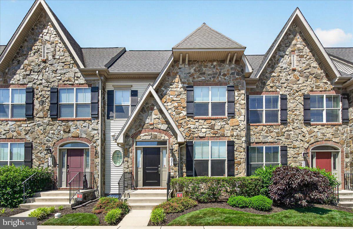 Welcome to this stunning Chateau-style townhome on desirable Mill Island in the highly sought-after Worman’s Mill community, where luxury, comfort, and an exceptional lifestyle come together. Beautifully maintained and lightly lived in, this home showcases quality upgrades and timeless finishes throughout.

Step inside to find 9-foot ceilings, rich hardwood flooring, and an elegant carpeted staircase. Formal living and dining rooms greet you at the front of the home, providing ideal spaces for entertaining. The gourmet kitchen features upgraded 42-inch cabinetry, granite countertops, a stylish tile backsplash, stainless steel appliances, a large center island with seating, and a separate breakfast area. Just beyond, the inviting family room offers a surround sound speaker system that conveys, a gas fireplace with mantel, recessed lighting, custom built-in bookshelves, and a built-in entry bench.

Upstairs, the spacious primary suite features dual walk-in closets with organizers and a luxurious en-suite bath with double vanities, a tiled glass-enclosed shower, and a soaking tub. Two additional bedrooms share a well-appointed hall bath with a dual-sink vanity, while the convenient upper-level laundry room provides added storage.

The finished lower level expands the living space with a large recreation room, full bath, and a sound-dampened bonus room ideal for a home theater, gym, or private office. An unfinished workshop offers excellent storage and future flexibility. Workbench and chair convey.

Outdoor living is equally impressive with a fenced 24-foot-wide backyard, expansive paver patio, and easy access to the detached two-car garage and a separate gate for rear alley entrance. It's worth mentioning that the front of this home sits adjacent to single family homes with driveways and garages and therefore allows for more street parking for guests and visitors. 

Enjoy all that Worman’s Mill has to offer, including scenic walking trails, ponds and fountains, community events, neighborhood restaurants, and direct access to the Monocacy River via the Bluebell Trail for kayaking and outdoor recreation. Conveniently located just minutes from downtown Frederick, shopping, dining, and commuter routes.

This exceptional home combines elegant living spaces, thoughtful upgrades, and outstanding community amenities in one of Frederick’s most desirable neighborhoods. Don't miss this rare opportunity to experience the best of Worman’s Mill living.
