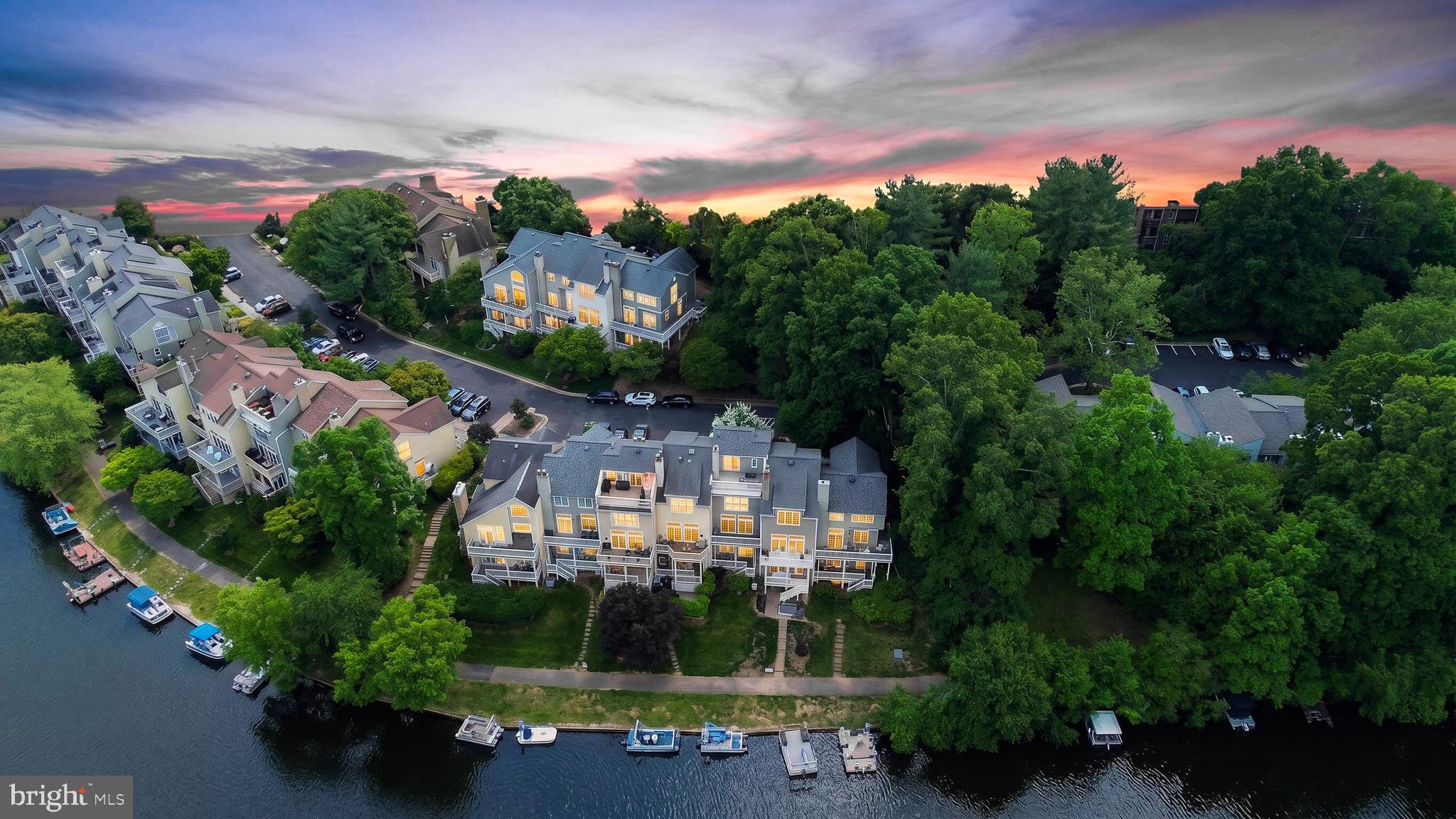 Welcome to one of Reston’s most exceptional waterfront residences — a rare opportunity to own a beautifully renovated townhome with unobstructed lake views from every level, every season of the year. Perfectly positioned along the water, this remarkable 3-bedroom, 3.5-bath home offers a lifestyle defined by serenity, elegance, and timeless scenery.

Thoughtfully redesigned throughout, the home showcases new hardwood flooring, sophisticated modern finishes, and an abundance of natural light that frames the breathtaking waterfront backdrop from nearly every room. The completely renovated kitchen features stainless steel appliances, sleek cabinetry, and refined details curated for both everyday living and effortless entertaining.

Each bathroom has been meticulously transformed with designer-selected tile, contemporary fixtures, recessed lighting, and spa-inspired finishes, creating a luxurious and cohesive aesthetic throughout the home. The residence has also undergone extensive capital improvements, including a newer roof, a 1.5-year-old HVAC system, new energy-efficient Pella sliding doors, a new front entry door, and a new oversized washer and dryer — offering both modern comfort and peace of mind for years to come. Additional enhancements include new siding and striking modern glass railings that elevate the home’s clean architectural lines and open feel.

Step outside onto your private balcony and unwind while overlooking the tranquil water — the perfect setting for morning coffee, evening sunsets, or peaceful moments surrounded by nature. Located in a quiet and highly desirable lakeside community, residents enjoy direct access to canoeing, boating, and waterfront recreation, complete with an available boat slip for your personal watercraft. The property also conveys with two assigned parking spaces (#3) for added convenience.

A truly rare offering combining sophisticated renovations with year-round panoramic lake views — this is waterfront living at its finest.