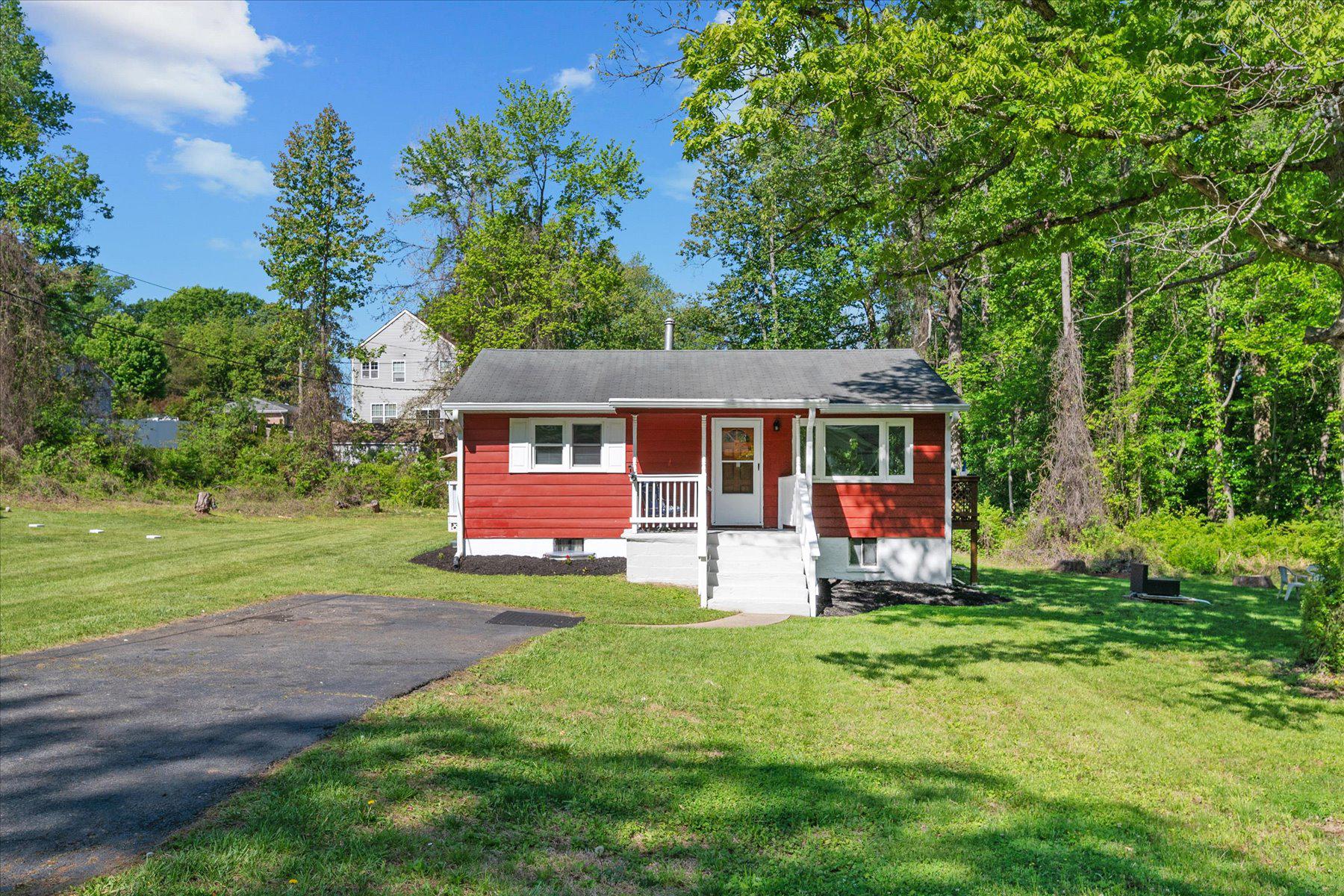 Move-in ready rambler with 4 bedrooms and 2.5 baths.  The home includes new luxury flooring, new windows, new gutters,  GE stackable washer and dryer with steam technology.

The sizable primary suite features a private bath, walk in closet and access to a sun-filled deck overlooking a peaceful, wooded backdrop, offering rare privacy and a true connection to nature.

Enjoy a large waterproofed unfinished basement ready for your vision, plus three 7,500 sq ft lots totaling over half an acre, ideal for outdoor living.

Tucked on a quiet street near a natural pond and surrounded by mature trees, this home offers a serene and peaceful setting while still being under a mile from the scenic 11.7-mile WB&A Trail.

Conveniently located near shopping, restaurants, schools, worship centers, hospitals, and major commuter routes with easy access to NASA, Kaiser, UMD, MARC, New Carrollton Metro, Amtrak, and major highways.

No HOA dues, plenty of off-street parking, and priced to allow room for customization. This is your rare opportunity to create value while enjoying space, privacy, and location.