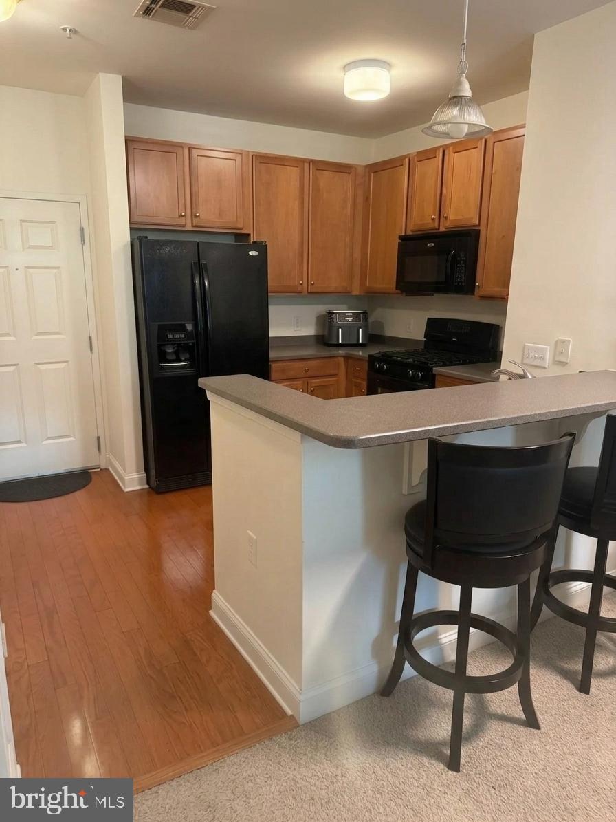 Discover easy, maintenance-free living at 200 W. Elm Street, Unit 1108. This desirable Dresher floor plan offers a spacious and inviting layout designed for both everyday comfort and entertaining. The well-appointed kitchen showcases Corian countertops, a breakfast bar for casual dining, and black appliances, all opening to a sun-filled living and dining area.

A versatile bonus room provides the flexibility to fit your lifestyle, whether used as a home office, reading nook, nursery, or extra storage space. Enjoy the convenience of an in-unit washer and dryer, and unwind on your private balcony accessed through sliding glass doors.

The home includes one deeded underground garage parking space, with ample guest parking available for visitors. Residents have access to exceptional community amenities, including a swimming pool, fitness center, and outdoor gathering areas complete with grilling stations.

Ideally situated near the Valley Forge and Schuylkill River Trail systems, this location places you within walking distance of Conshohocken's vibrant dining, shopping, nightlife, and public transportation options. King of Prussia Mall, major highways, and Center City Philadelphia are all just a short drive away, making commuting and entertainment effortless.
