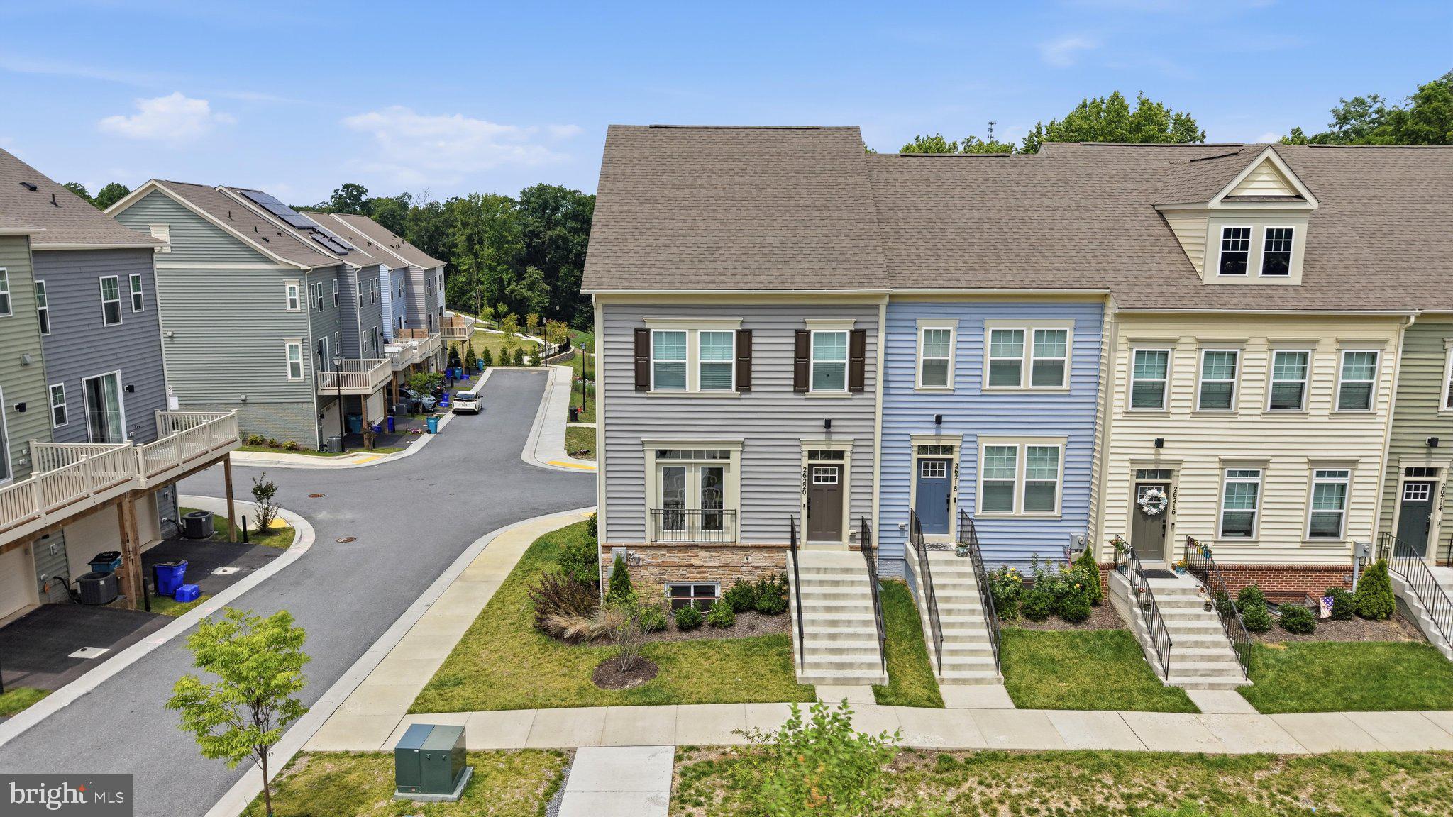 Welcome to 26220 Queens Grove Ter, a sun-drenched, move-in-ready END-UNIT townhome built in 2024 and offering approximately 2,248 finished square feet across three levels. The end-unit position delivers extra windows on the side elevation that flood the open-concept main level with natural light all day, a private view of mature greenery out front, and a tot lot just steps from the garage in the rear. Luxury vinyl plank flooring runs throughout the entire main level. The open kitchen showcases a spacious center island with breakfast bar seating, herringbone tile backsplash, stainless steel appliances, and light, airy cove-colored cabinetry that complements the abundant natural light. Oversized windows brighten every room, and sliding glass doors open to a private rear deck overlooking the community green space and play area. Upstairs are three generously sized bedrooms including a primary suite with en-suite bath and walk-in closet, plus convenient bedroom-level laundry. The finished lower-level game room with full bath offers flexible space for a home office, guest suite, media room, or second living area, and the attached garage provides driveway parking and direct interior access. Minutes to Damascus Shopping Center, Weis Markets, Main Street dining, and Damascus Recreational Park, with Clarksburg Premium Outlets and Germantown shopping a short drive away. A commuter's dream with direct access to MD-27 (Ridge Road) and MD-108 (Damascus Road), plus I-270 via Clarksburg and I-70 to the north. Damascus school cluster: John T. Baker Middle School and Damascus High School (buyer to verify current MCPS boundary assignments). Barely two years young, beautifully maintained, and ready for immediate occupancy. Schedule your private tour today.