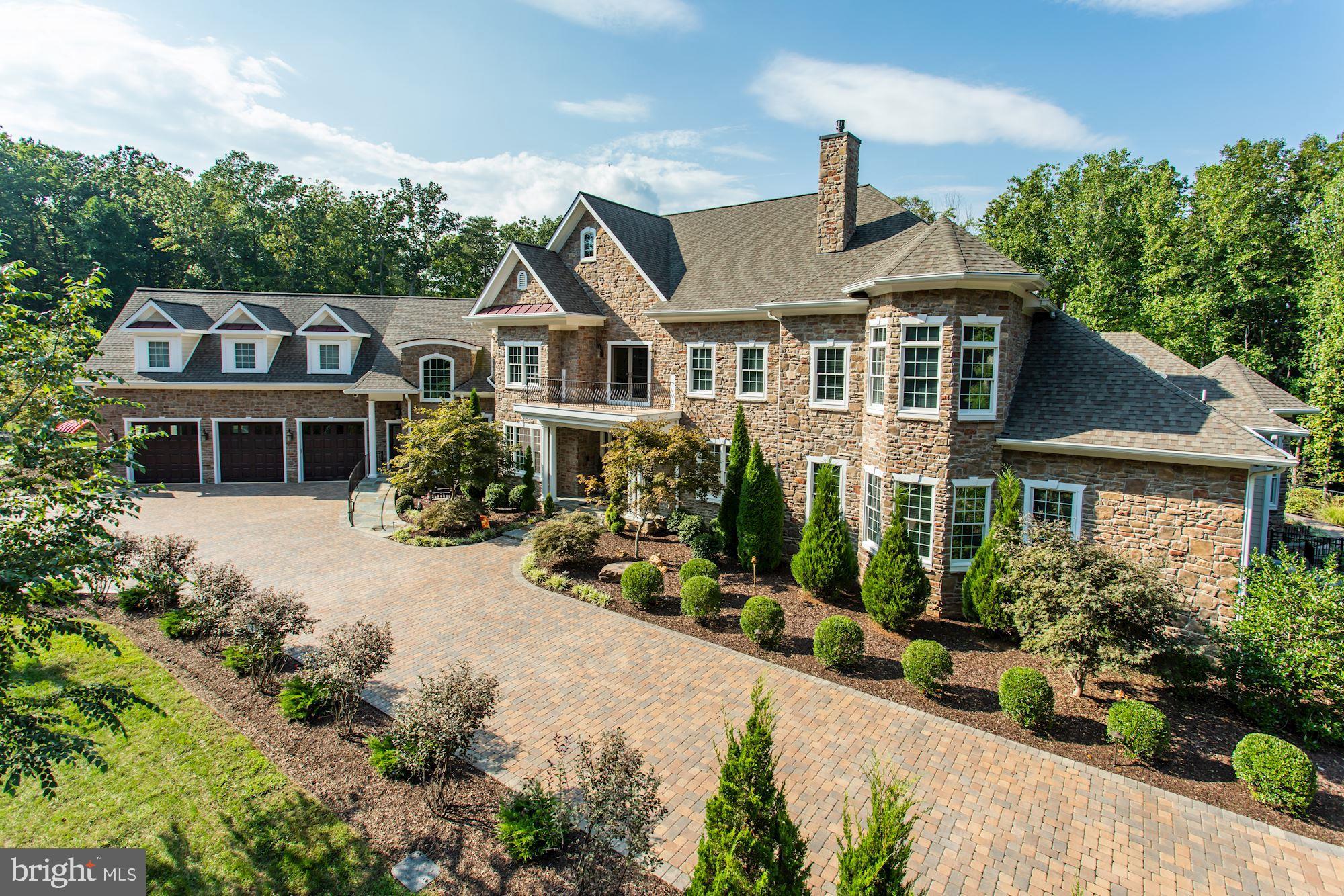 It is with great pride that we present this exquisite, beautifully appointed,   custom built executive  estate, perfect for year round entertainment possibilities for family, friend and business associates.  It is truly "One of a Kind" in style, quality and craftsmanship.  It IS "Your Forever Home"!   In addition to five bedrooms, including four en-suites with walk-in closets, the nearly 13,000 SF custom home includes: an indoor, heated swimming pool with cathedral ceilings, faux wood beams and floor-to-ceiling custom windows; a 3-Season screened solarium with access to the pool, main level, and expansive patio and backyard; a two-lane, regulation-size Brunswick Bowling Alley; and Home Theater/Media Room and Bar.  The 3-level home also features hand scraped, hardwood floors throughout, a large, gourmet kitchen with an expansive center island, large dining room, living room, several family living areas, seven bathrooms, four gas fireplaces, elevator, custom designed closets, security cameras, and a sophisticated security system.  Nearly three acres of the fenced-in ten+ acre property has been professionally designed with landscape and hardscape to blend seamlessly into the woods and trees beyond, including water access to the Occoquan River. The property is accessed securely via two wrought iron gates.Additional custom features include: Main level, open floor plan with state-of-the-art gourmet kitchen with commercial-grade Thermador appliances, including Range, Wall Oven and Microwave, built-in column style refrigerator and freezer; walk-in pantry, second refrigerator; granite countertops; porcelain farm-style sink and hammered copper bar sink; built-in Thermador column-style wine refrigerator; upgraded cabinetry, and a separate Eating Area with bay window .Main level also includes a Master Suite complete with an expansive walk-in  closet, with access to the patio and backyard; Second-Master Suite; Laundry room; Powder Room; Library with fireplace and built-ins; and, a Great Room that leads to a covered porch onto the large patio and gazebo area. The Upper level includes a family room with wet bar area, featuring a hammered copper sink, refrigerator, and upgraded cabinetry; covered Balcony overlooking the backyard; second laundry room, a second walk-out balcony that overlooks the front yard; and an expansive bonus room. The Lower Level includes an open Home Theater; custom bar with hammered copper sink, refrigerator, exotic granite and separate pub style seating; 2-lane regulation bowling alley; home gym with mirrored wall and cushioned, rubber flooring; full bath; and a craft / shop area complete with a full-size sink. The home was designed to Age in Place,  with features including, but not limited to: an access/egress ramp that integrates seamlessly with the hardscape; elevator, wide doorways, door-free walk-in showers; and lever-style door handles and faucets throughout. Added protection with a whole house Generac generator system. The home was built in 2014 by Mike Garcia Construction, Inc., Woodbridge, VA; Architectural Design by Sandhya Gorur, AIA, Another Angle Design, Centreville, VA; Interior Design by Lorna Gross, ASID, Lorna Gross Interior Design, Bethesda, MD.  The home was featured in the 2015 January / February issue of Home and Design Magazine.This is a spectacular property designed to complement and incorporate the surroundings, emphasizing the elements of wood, stone and light, and maximizing the views of nature with a nearly 360-degree view of the property grounds. It is perfect balance with quiet, wooded surroundings, incredible quality, and unlimited opportunities for entertaining family and friends, all the while being close to major transportation and everything that the Washington DC area has to offer.
