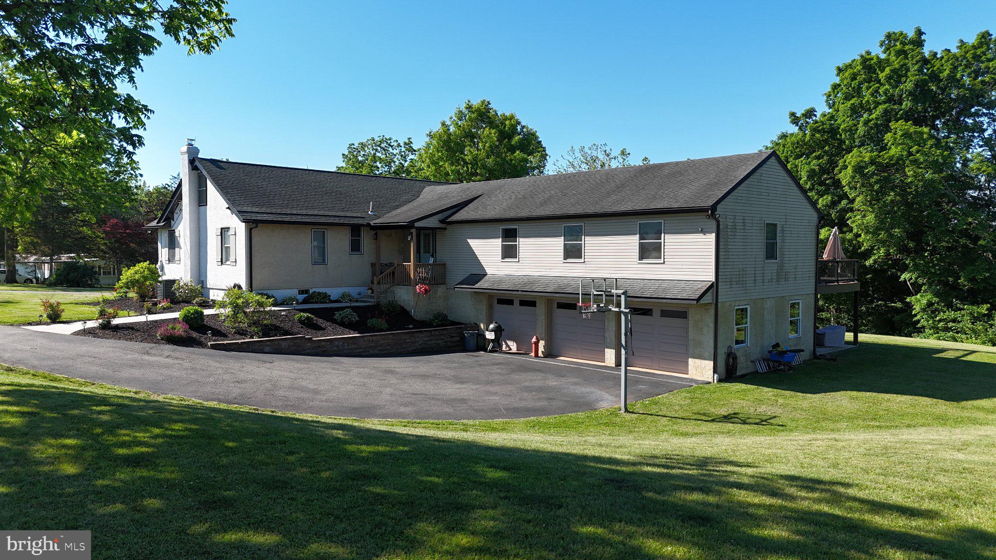 Welcome to 44 Worman Road, a beautifully updated ranch home set on 4.85 private acres in the Daniel Boone School District. Offering more than 2,500 square feet of living space, this unique property seamlessly blends the charm of its original 1930 construction with the comfort and convenience of a thoughtfully designed 2010 addition. The heart of the home is the stunning gourmet kitchen, featuring custom cabinetry, a massive center island, pantry, wine cooler, and abundant workspace for cooking and entertaining. The kitchen flows effortlessly into the spacious dining area and family room, where vaulted ceilings, an electric fireplace, and luxury vinyl plank flooring create a warm and inviting atmosphere. The private primary suite, located within the addition behind a 6-inch wall with added insulation for enhanced sound reduction, serves as a true retreat with a spa-inspired en suite bathroom complete with heated floors, double vanity, and stall shower. Three additional bedrooms are situated in the original portion of the home and share a beautifully renovated full bathroom. A formal living room and dedicated laundry room provide additional functionality and living space. Throughout the home, you'll find luxury vinyl plank flooring, craftsman-style molding, and updated light fixtures that add a cohesive and modern touch. Step outside to the large rear deck overlooking the expansive backyard and wooded backdrop, offering exceptional privacy and a peaceful setting for outdoor enjoyment. Additional features include an electric dog fence and an oversized three-car garage on the lower level. For added peace of mind, a brand-new septic system has already completed the design phase and will be installed prior to closing. If you've been searching for a property that combines acreage, privacy, modern updates, and timeless character, 44 Worman Road is a rare opportunity you won't want to miss.