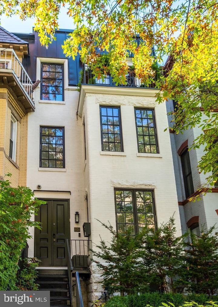 This captivating rowhouse graces a charming residential street, offering an unbeatable location that places the very essence of Washington right at its doorstep. Total home transformation in 2018 by acclaimed BOWA design build experts.  Boasting over 3,500 square feet, this stunning residence showcases a seamless blend of historic charm and modern luxury. 

Step inside to discover an impressive entry level featuring a dramatic living room with a fireplace, a spacious dining room, an exquisite half bath, and a well-appointed kitchen adorned with custom cabinets and high-end appliances. Sunlight pours in through a wall of French doors, inviting you to an expansive rear patio, perfect for outdoor living and accommodating multiple cars.

Ascending to the first upper level, the owner's suite takes center stage, offering a generously sized bedroom with a fireplace, an office nook, and a designer bathroom adorned with Waterworks fixtures, a steam shower, heated floors, and a freestanding bathtub. Custom closets with thoughtful details provide ample storage.

The second upper level houses an elegant office with custom shelving, two tastefully renovated bedrooms, two bathrooms, and a balcony adorned with lush plantings. A rooftop retreat awaits above, featuring a dining area, entertaining space with a fireplace, and a lounge area with remote-controlled louvers—an exceptional space for year-round enjoyment.

The lower level, accessible through a separate entrance, unveils a large bedroom, a high-end bathroom, a custom gym with a steam shower, a family room, and a laundry room. Abundant storage options, including a Subzero wine fridge with space for 150 bottles, complete this level.

With four meticulously finished floors showcasing top-tier craftsmanship, secure parking for up to four cars, and an elevator servicing each floor, including the rooftop oasis, this residence epitomizes the pinnacle of modern living. Welcome to a home where historic elegance meets contemporary sophistication. 

 Finishes and Remodel:
- Viking, Bosch and Wolf kitchen appliances including double ovens, grill, a warming drawer, and double dishwashers
- Full-size 150 bottle Viking wine fridge
- Two steam showers
- LG Styler Steam Closet
- Waterworks faucets and showers
- Lutron home automation lighting system
- Datawatch alarm system
- Trane HVAC split into three zones
- SunBriteTV outdoor TV
- Plumbed high-end grill
- Three indoor and one outdoor gas fireplaces
- Marble countertops
- Electrified remote controlled louvers for sunshade on the roof deck
- Whole house water softener and chlorine filter
