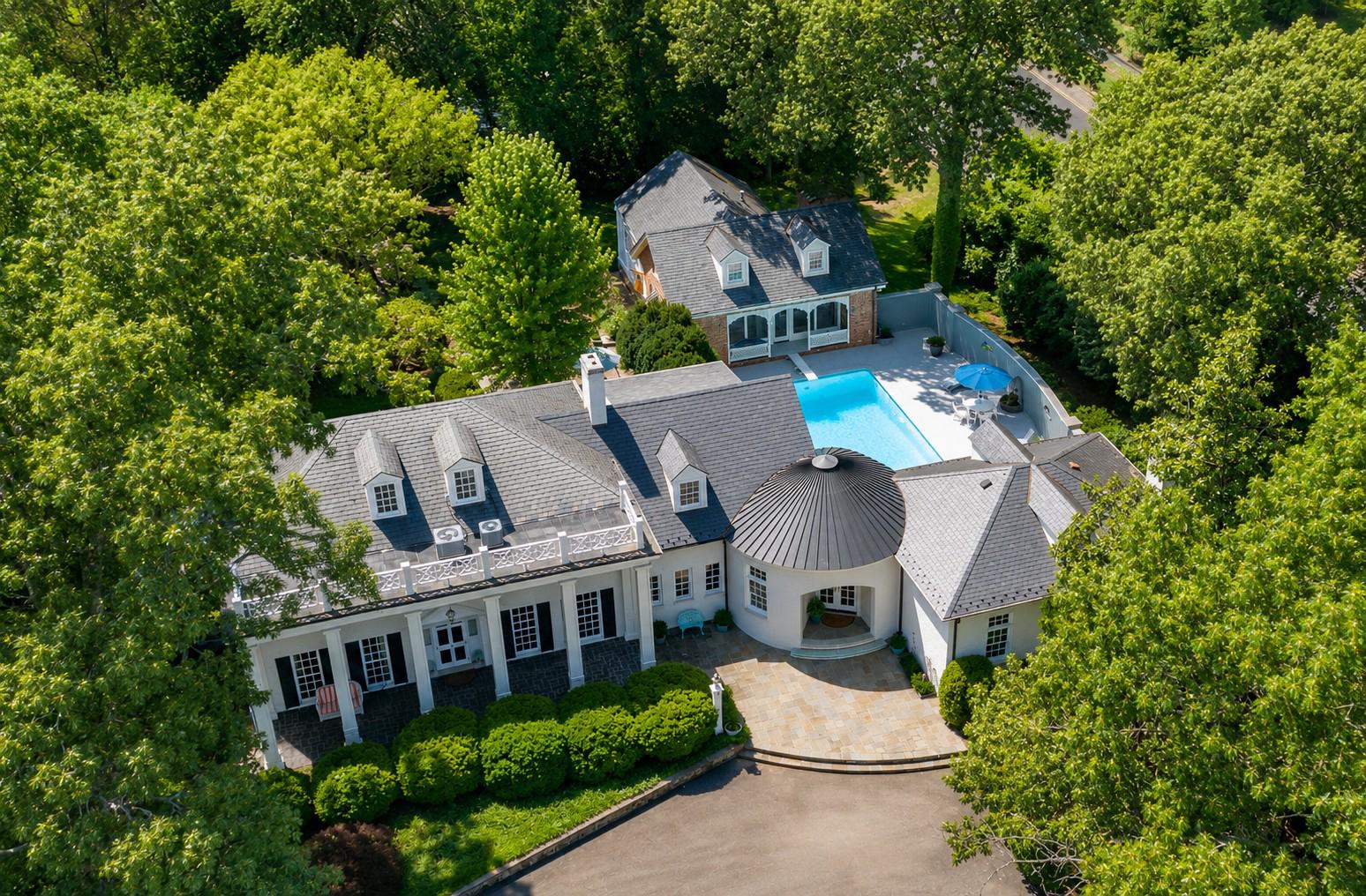 For the first time in its history, one of Fredericksburg's most remarkable private residences is preparing to welcome its next owner.

Built in 1946 by the father of the current owner, this extraordinary Colonial has remained in the same family for generations. Perched at the end of Beverly Drive, the estate is a masterclass in timeless architecture, craftsmanship, and thoughtful design, where every addition and every detail reflect decades of careful stewardship.

From reclaimed architectural elements and custom ornamental ironwork salvaged from historic Richmond homes to sea glass countertops in the guest house, this is a home filled with stories that cannot be replicated. The formal garden terrace, anchored by a gazebo crafted from ironwork cut by the historic James River Foundry, overlooks mature landscaping designed to evolve beautifully with every season.

You are welcomed inside the home by gracious living spaces designed for both elegant entertaining and everyday comfort. The light-filled gourmet kitchen and soaring family room, complete with a wet bar and impressive fireplace surrounded by built-ins, create a spectacular gathering place, while formal and intimate spaces offer equal measures of sophistication and warmth. The owner's suite is a private retreat featuring dual walk-in closets and a luxurious spa-inspired bath. Each additional bedroom enjoys its own ensuite bath, providing exceptional comfort for family and guests alike.

The detached guest house offers a full kitchen, bedroom and full bath with roll-in shower on the main level, loft bedroom, and custom finishes, creating an ideal space for extended family, visitors, or a private retreat. Outside, expansive slate patios, terraced gardens, an Olympic-sized in-ground marbelite pool, and countless handcrafted details transform the grounds into a true private estate.

Opportunities like this are exceptionally rare. More than a home, this is a legacy property waiting for its next steward.

Coming Soon.