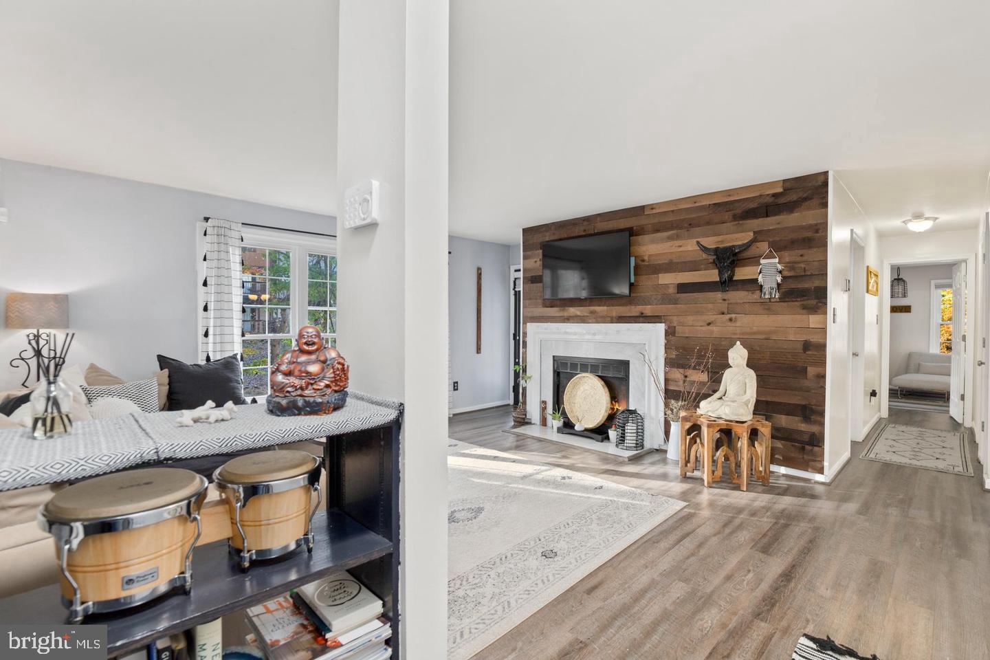 Beautiful ground-level corner unit in the wooded Bristol House condo community! Enjoy the spacious and open floor plan, featuring large living room with dramatic wood panel accent wall and walkout to patio, dining area, and gorgeously updated kitchen granite counters, and stainless steel double door refrigerator and range. The large primary bedroom features a large walk-in closet, access to patio, new 
 vanity area, and an attached dual-entry bathroom. Enjoy the on-trend wide plank LVP and neutral paint throughout!  back patio offers plenty of space for entertaining or relaxing, all while enjoying the serene wooded views! HVAC and water heater were installed in 2017. Thousands of $$$ in NEW windows and sliding glass doors!! In-unit washer/dryer and assigned parking included. Community amenities include tennis courts, walking trails, tot lot, as well as access to the many fantastic Reston Association amenities (pools, tennis courts, walking/jogging trails, lakes & more!). Great location - close to the Reston Metro, Dulles Toll Road, and Reston Town Center. Electric fireplace.