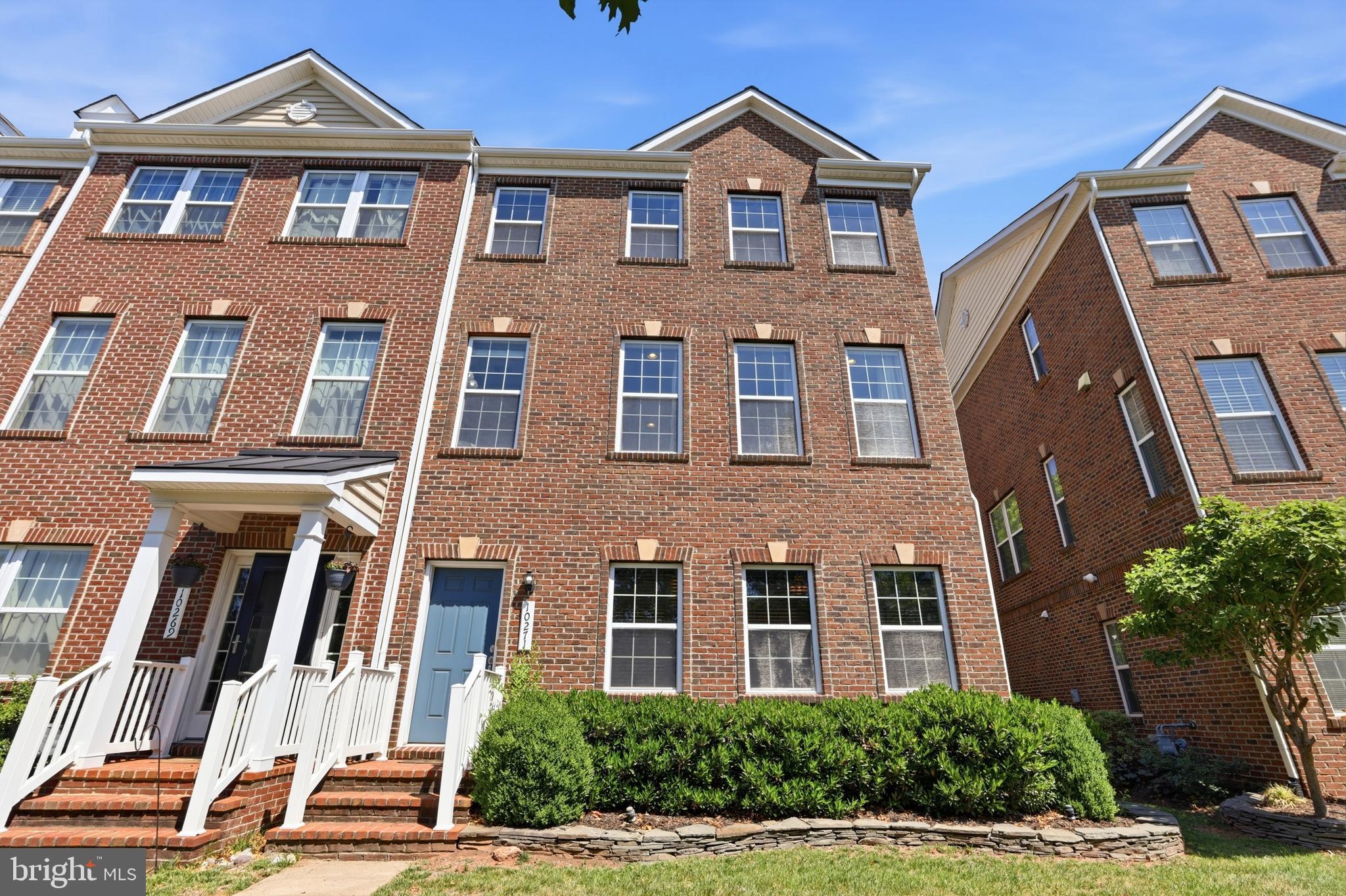 Gorgeous and packed with upgrades, this brick front townhome offers incredible space across 2,400+ square feet. Hand-scraped hardwood floors flow throughout all three levels. The convenient walk-in lower level features a bedroom that works perfectly as an office, a full bathroom, and access to the spacious rear two-car garage. On the main level, 9-foot ceilings and oversized windows create a bright and open feel that carries into the gourmet kitchen, complete with a large island with pendant lights, stainless steel appliances, generous espresso cabinetry paired with light granite/quartz countertops, recessed lighting, and a custom backsplash. The sunny breakfast room opens to a Trex deck with privacy partitions. Every detail has been carefully considered — painted ceilings, extensive moldings throughout every room and bathroom, a cozy three-sided fireplace, and built-in speakers on the main level make this home as functional as it is elegant. Every bathroom features upgraded tile and hardware. The primary bedroom is generously sized with a large walk-in closet, tray ceiling, double crown molding, and a luxurious ensuite bathroom with a spacious frameless glass shower. Upper level laundry is an added bonus. This home truly delivers comfort and style in equal measure — and with shopping, restaurants, and everyday conveniences just steps away. You must see!