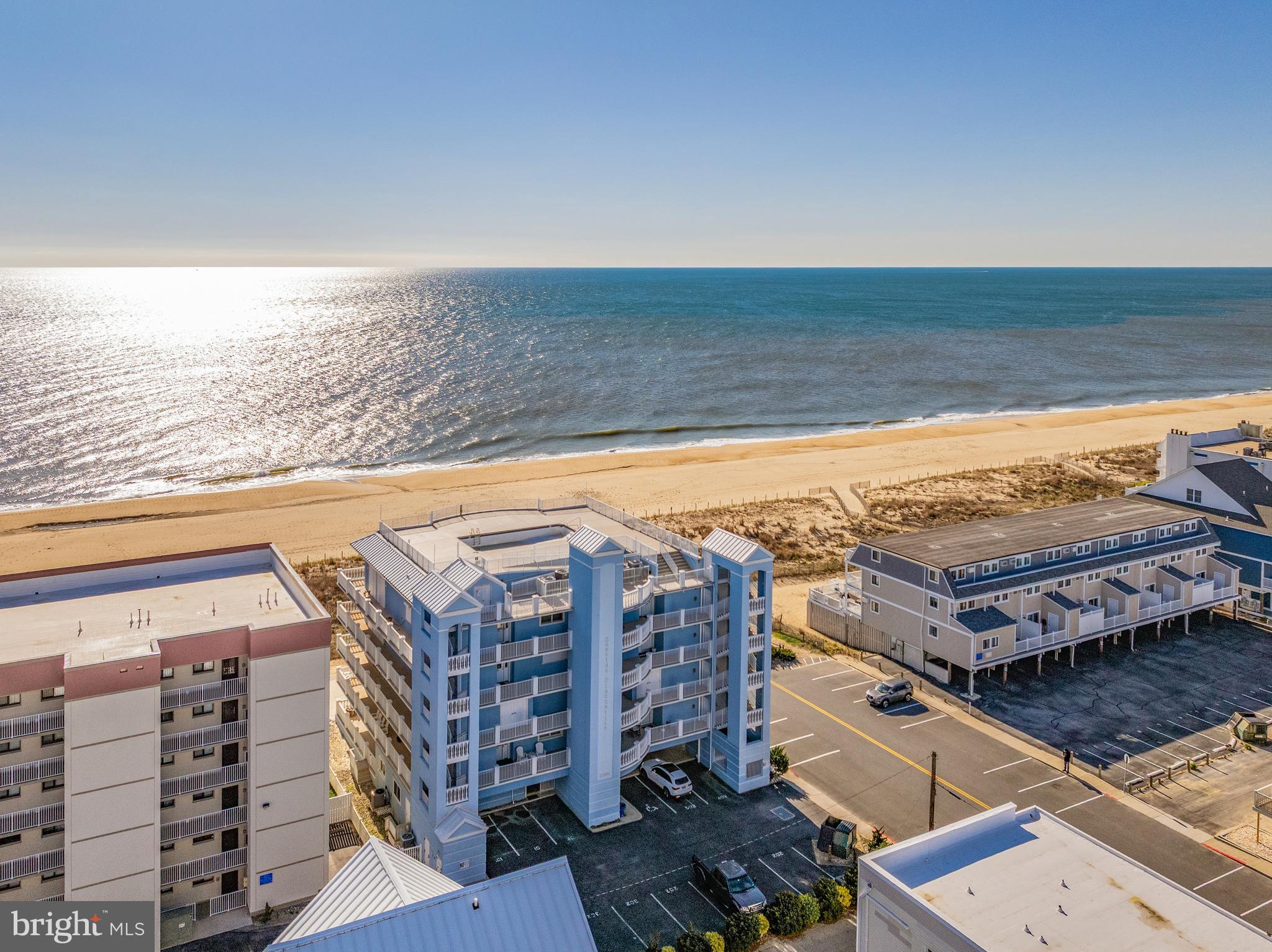 Experience the pinnacle of coastal luxury in this truly one-of-a-kind direct oceanfront residence. Spanning more than 4,000 square feet and occupying the entire third floor of an exclusive boutique building with just eight residences, this extraordinary condo offers an unmatched level of privacy, space, and sophistication.
Designed with both comfort and elegance in mind, this stunning home features five spacious bedrooms, each with its own private ensuite bath, plus an additional half bath for guests. The expansive primary suite is a private retreat of its own, complete with a cozy sitting room, fireplace, and a spa-inspired luxury bath. A dedicated private office provides the perfect work-from-home setup without sacrificing the serenity of your oceanfront surroundings.
At the heart of the home, the gourmet kitchen is thoughtfully designed for effortless entertaining, featuring two refrigerators, two sinks, two ovens and two dishwashers—ideal for hosting family and friends with ease. The open-concept living and dining areas are filled with natural light and showcase breathtaking panoramic ocean views.
Step outside to your spectacular 1,200+ square foot balcony and take in the soothing sea breeze, endless ocean vistas, and unforgettable sunrises. This expansive outdoor living space is perfect for morning coffee, al fresco dining, or simply relaxing while listening to the waves.
Practical luxury continues with five dedicated parking spaces, including two covered spots—an exceptional convenience at the beach. After a day in the sand and surf, unwind with a refreshing swim in the rooftop pool while enjoying sweeping coastal views.
Custom built during original construction; this residence offers thoughtful details and features that simply cannot be replicated. For added peace of mind, no short-term rentals are permitted, creating a quieter, more private atmosphere and preserving the exclusive feel of the building.
This is a rare and remarkable opportunity to own an exceptional oceanfront home that offers the space of a single-family residence with the ease and convenience of luxury condo living.