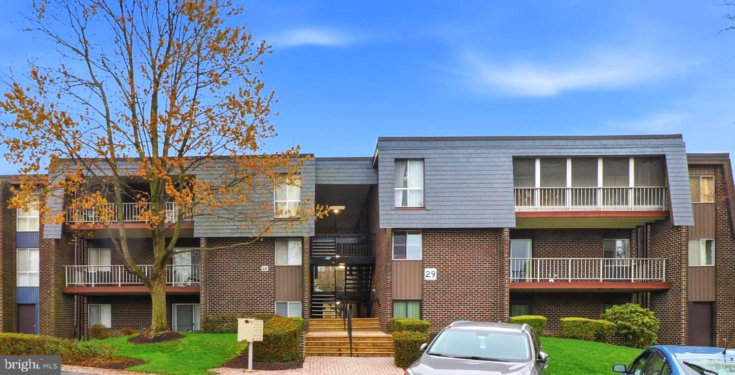 Discover the charm of this beautifully maintained 2-bedroom, 2-bathroom garden-style condo in Stevenson Village! With 1,203 sq. ft. of inviting, freshly painted living space, this home features a seamless blend of comfort and functionality. The open-concept design creates a warm atmosphere, perfect for both relaxation and entertaining. Enjoy the convenience of an updated eat-in kitchen equipped with modern appliances, including a dishwasher, electric oven, washer/dryer, and refrigerator, complemented by ample pantry and cabinet space. Natural light floods the living area, accentuated by recessed lighting and elegant wood parquet floors. The primary suite boasts a spacious walk-in closet and a private bath, while the second bedroom offers flexibility for guests or a home office. Additional features include built-ins, ceiling fans, fully enclosed porch for year round enjoyment, and window treatments that enhance the cozy ambiance. Step outside to enjoy the community amenities, including a sparkling in-ground pool, clubhouse, and beautifully landscaped common grounds. The secure environment, complete with a security gate and exterior cameras, ensures peace of mind. With two assigned parking spaces and easy access to beautifully paved walkways, convenience is at your doorstep. Enjoy three ways to enter your new condo with two No Step entries! Surrounded by lush gardens and trees, this home offers a serene view that invites you to unwind. Move in now to enjoy the upcoming pool season. Experience the perfect blend of comfort, community, and convenience in this delightful condo—your new sanctuary awaits!!
