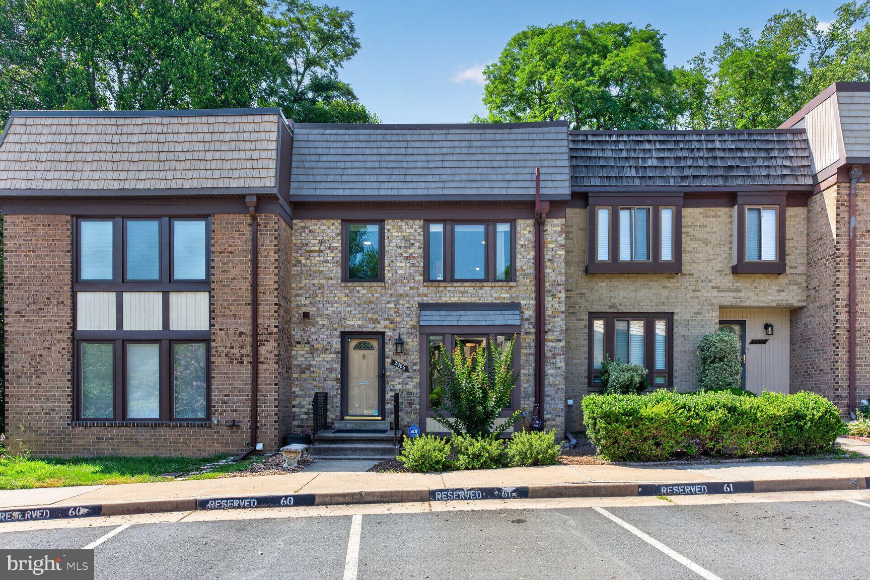 Tastefully updated and meticulously maintained home (2573 sq.ft. ) in prime location near schools, parks, shopping, restaurants, GMU ,Vienna Metro and several major commuting routes.  This sun-filled 3 levels brick home offers an open -floor plan and modern design upgrades. On the main level you find the spacious living/dining area with high ceilings and a bay window , a guest bath, an expanded eat-in kitchen with two pantries that spans the width of the house and opens to a serene deck and patio surrounded by mature landscape.  The upper level features a very large primary suite with sitting/nursery  area, two walk-in closets, en -suite bath plus two additional generously sized bedrooms and full bathroom.  The lower level adds valuable living space  features a large recreation room with a fireplace, full bath and ample storage and laundry areas. Upgrades include high efficiency windows, extra insulation, luxury vinyl plank flooring, recessed lights throughout, upscale bathrooms, fresh paint and much more! The home includes two assigned parking spaces (right outside the main entrance door), plus additional visitor parking. The HOA covers lawn care, snow removal, trash/recycling  collection and community ammenities which include pool, BB & tennis courts, gym. The combination of quality/elegant architecture, convenient location, top rated schools, and welcoming community make this home an ideal opportunity for homeownership!