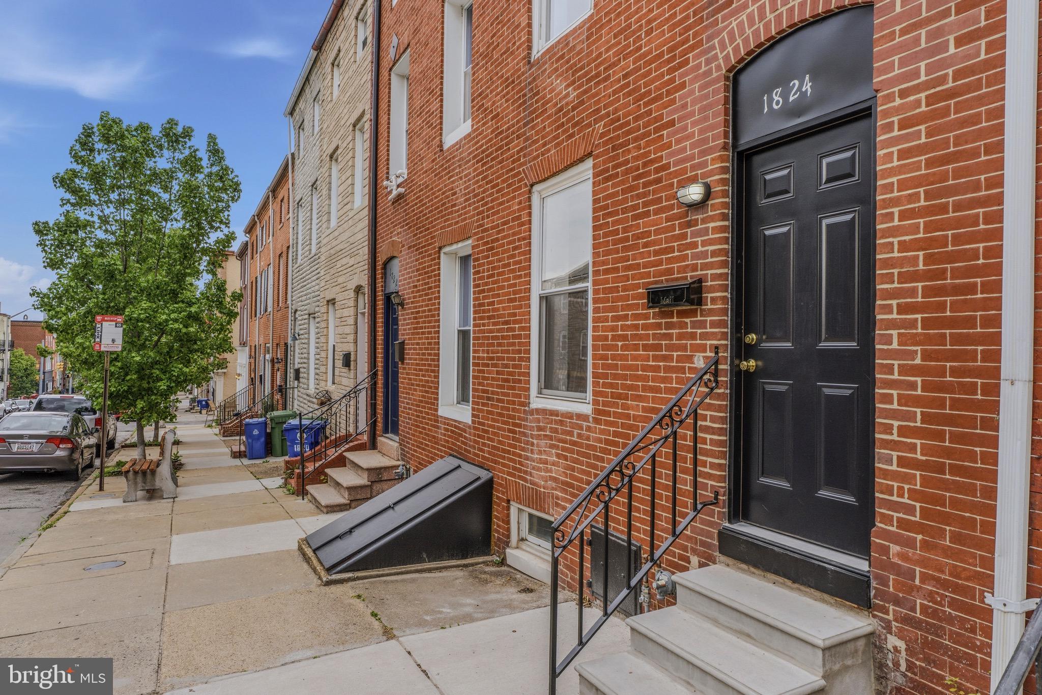 OPEN HOUSE this Saturday, July 4th from 10am-12pm. Check out this townhome centrally located west of Patterson Park and north of Fells Point.  This location allows for easy walkability to area restaurants and businesses.  This home has had many updates and upgrades but retains historic charm with exposed brick and wood beams throughout the home. 
Main level has hardwood flooring in the open Living Room and Dining room area.  Kitchen has wood cabinets, stainless appliances, and granite countertops.  There is also a main level full bathroom and Laundry room.  Heading upstairs to the 2nd level, you'll see the hardwoods carried throughout the hallway and bedrooms.  There are two bedrooms and a 2nd full bath on this level.  Another staircase takes you to the 3rd story Primary Bedroom suite that is spacious enough for a sitting room area.  With its exposed beams and brick, this area creates a private retreat.  The home has a fenced backyard with Patio and back alley access to the side street.  There is plenty of storage in the Basement too.  Act quickly!  This one won't last!!!