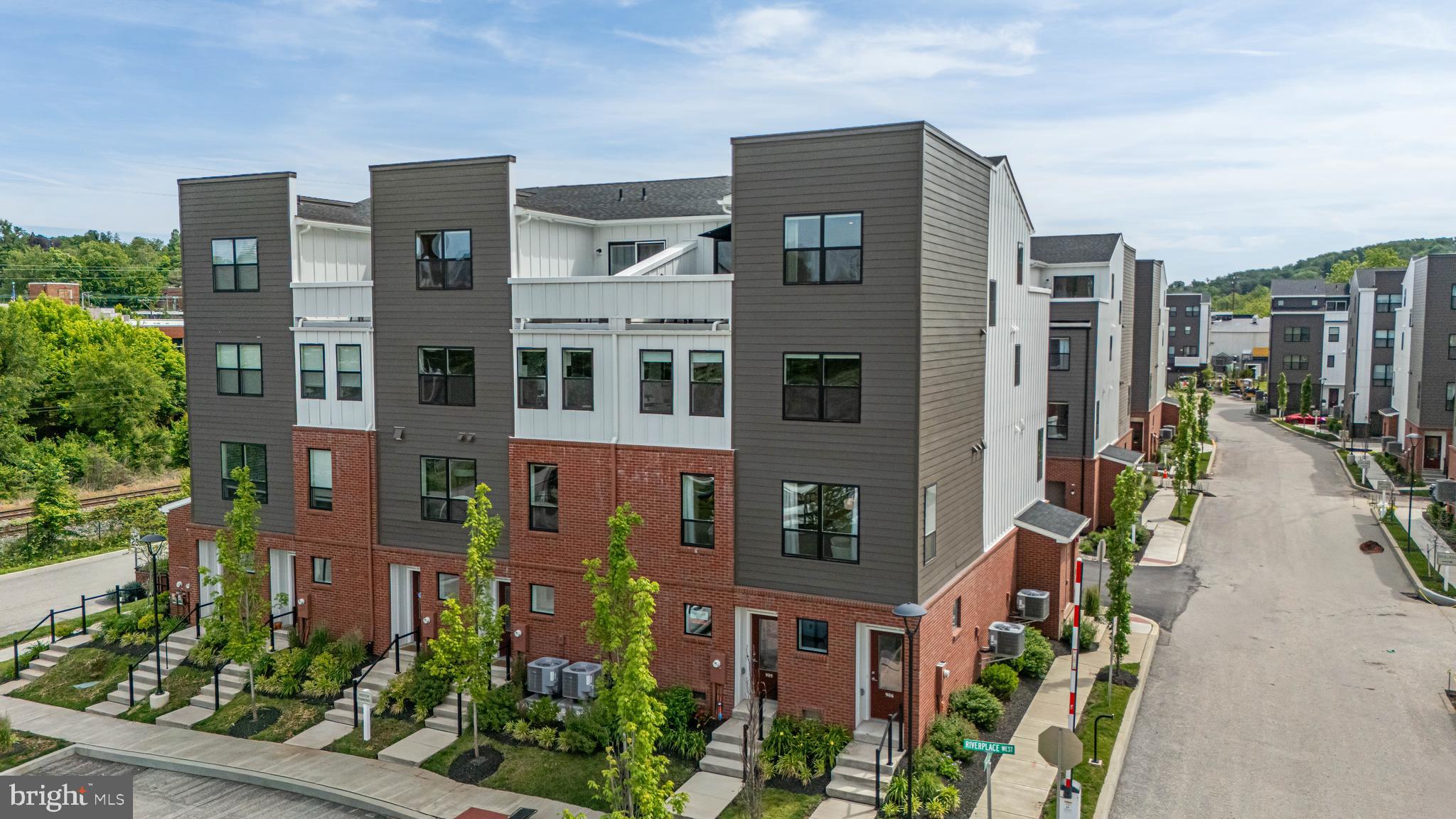 Introducing 905 Riverplace Drive — Available because of seller relocation only, a rare opportunity to own the former Heron model home in River Place, recently named “Best New Townhome Community of the Year” for 2026. Just two years young and loaded with over $100,000+ in premium upgrades, this progressive riverfront townhome combines sophisticated design, low-maintenance living, and unbeatable walkability in one of Conshohocken’s most exciting new communities.
Inside, this stunning 3-bedroom, 2.5-bath residence features tall ceilings, oversized windows, Luxury Vinyl Plank flooring, upgraded lighting and recessed lighting throughout, and an open-concept living level designed for entertaining. The designer kitchen showcases white Inglis shaker cabinetry, Level 2 quartz countertops, peninsula seating with additional storage, GE Profile stainless steel appliances, gray subway tile backsplash, and under-cabinet lighting. Dual owner suites each offer walk-in closets, while the top-level retreat includes a wet bar package and access to a private rooftop deck with serene river views.
Additional highlights include a tandem 2-car garage with custom epoxy flooring, upgraded carpeting, architectural details inspired by the area’s industrial heritage, underground utilities with fiber optic service, and HOA-maintained snow removal and lawn care for effortless living. Available for quick settlement. Some furnishings may be available for purchase as well.
River Place residents enjoy exclusive amenities including a pocket park, riverfront walking trail, and scenic observation decks — all within walking distance to Conshohocken’s restaurants, shopping, fitness studios, nightlife, and more. This is more than a home — it’s a turnkey luxury lifestyle along the river.
Perfectly positioned just a five-minute walk to SEPTA’s Spring Mill Station and adjacent to the Schuylkill River Trail, River Place offers exceptional convenience with quick access to I-476, I-76, the PA Turnpike, and Center City Philadelphia in under 25 minutes — all within the acclaimed Colonial School District.
