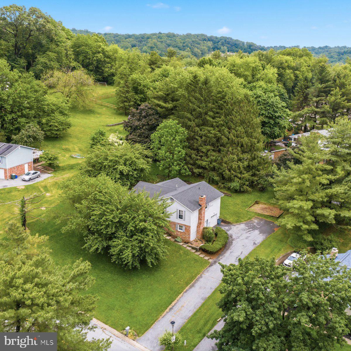 Welcome home to this spacious split-level offering 3 bedrooms, 2 full baths, and 1 half bath in a peaceful setting backing to mature trees for added privacy. Step inside to find a bright and inviting living room just off the front entry, perfect for everyday living or entertaining guests. The main level also features a formal separate dining room and an eat-in kitchen complete with stainless steel appliances, abundant cabinet storage, and plenty of countertop space. Just off the dining room, enjoy the large screened-in porch overlooking the level rear yard with a ceiling fan — perfect for the summer and an ideal space for relaxing or entertaining outdoors.

Upstairs, all three bedrooms are conveniently located, including the primary suite with its own attached full bath. Bedrooms two and three are serviced by a full hall bath with tub/shower combination. The first lower level offers a cozy family room with built-in shelving, fireplace, windows for natural light, garage access, exterior access to the driveway, and a convenient half bath. The second lower level includes a bonus room perfect for a home office, gym, or playroom, along with additional storage and utility space. Complete with a 1-car attached garage, this home offers flexible living space both inside and out.

Conveniently located near shopping, dining, parks, and commuter routes while still offering a quiet residential feel, this home combines comfort, functionality, and privacy in one desirable package.