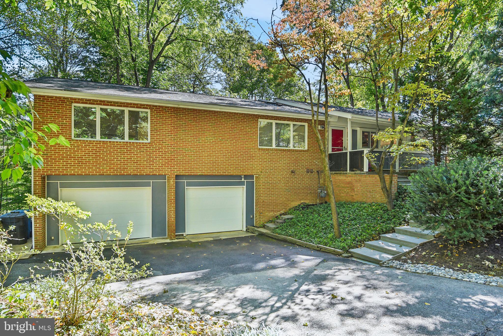 Mid-Century Modern in  Carderock Springs neighborhood, renowned for its exceptional architecture, 7709 Glenmore Spring Way offers a rare opportunity to own a home unlike many in the DC area. This stunning property sits high on a knoll, overlooking an expansive .4-acre lot with tree-top views, and walls of Anderson windows & doors, a hallmark of mid-century design. Professionally grade kitchen boasts high-end appliances and sleek flat-panel cabinets, large primary suite offers a private deck, walk-in closet, and heated floors, plus multiple outdoor spaces creating a serene environment. 

Additional features include a large oversized two car garage with direct access to the terraced and flat backyard and lower level patio, tons of extra storage on two levels, covered front porch, extensive hardscaping, & two fireplaces. The lower level also features a floating staircase, walls of windows & doors,  second kitchen, bedroom, & full bath. 

This property allows it's next owners exclusive opportunity to join Carderock Swim and Tennis club just 3 blocks away. Multiple swimming pools, tennis courts, pickelball, camps, and much more. The neighborhood's recognition on the National Historic Registry showcases its enduring charm, with covenants, an architectural board, and a tree committee dedicated to protecting its unique character and natural surroundings.

Located in the coveted Pyle/Whitman school district and with easy access to major commuter routes, this home delivers the perfect balance of size, floorplan, and private lot, making it a truly unique find. Don’t miss this rare opportunity to live in one of the most well-preserved Mid-Century Modern communities in the region.