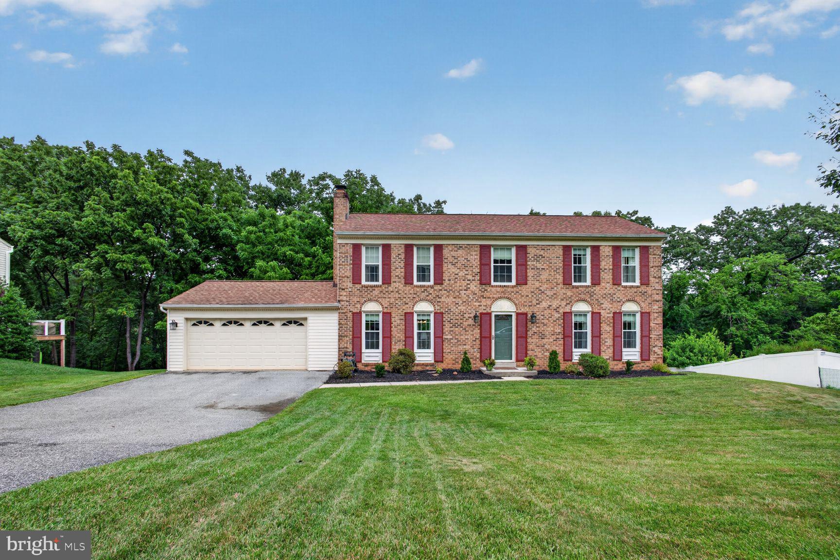 More exciting than the fireworks, this stately brick-front Colonial is ready to steal the show! Lovingly maintained by its original owners, this move-in ready 4 bedroom, 2.5 bath home offers over three finished levels of comfortable living, beautiful updates, generous room sizes, and a private wooded backyard complete with a peaceful stream.

From the moment you enter, you'll appreciate the timeless hardwood and tile flooring throughout the main level, where natural light fills the spacious living room and formal dining room—perfect for hosting holiday dinners, celebrations, and everyday gatherings. The beautifully remodeled kitchen is the heart of the home, featuring granite countertops, a tile backsplash, stainless steel appliances, abundant cabinetry, and plenty of counter space for meal preparation and entertaining.

Step outside onto the expansive deck stretching the entire length of the home, accessible from both the kitchen and dining room. Whether you're enjoying your morning coffee, grilling with friends, or cracking open Maryland crabs on a summer evening, the private wooded setting creates the perfect backdrop for relaxing and making memories.

Upstairs, you'll find four generously sized bedrooms, including a spacious primary suite, offering everyone room to spread out and unwind.

The partially finished walkout lower level adds even more flexible living space with brand-new carpeting in the recreation room, a separate bonus room ideal for a home office, fitness room, playroom, or craft space, plus a large storage room to keep everything neatly organized.

Out back, nature becomes an extension of your home. Mature trees, lush landscaping, and a gentle stream create a peaceful retreat where you can imagine reading in a hammock, watching wildlife, enjoying evenings around a fire pit, or even creating your own backyard adventure with a zip line.

Additional improvements include several newer windows, adding value and peace of mind.

Perfectly located just minutes from schools, shopping, restaurants, Liberty Reservoir, Piney Run Park, and major commuter routes, this home combines everyday convenience with the tranquility of nature.

Homes offering this combination of space, updates, privacy, and location don't come along often. Do you hear the fireworks? That's your excitement telling you this could be the one. Schedule your private showing today before the grand finale belongs to someone else!