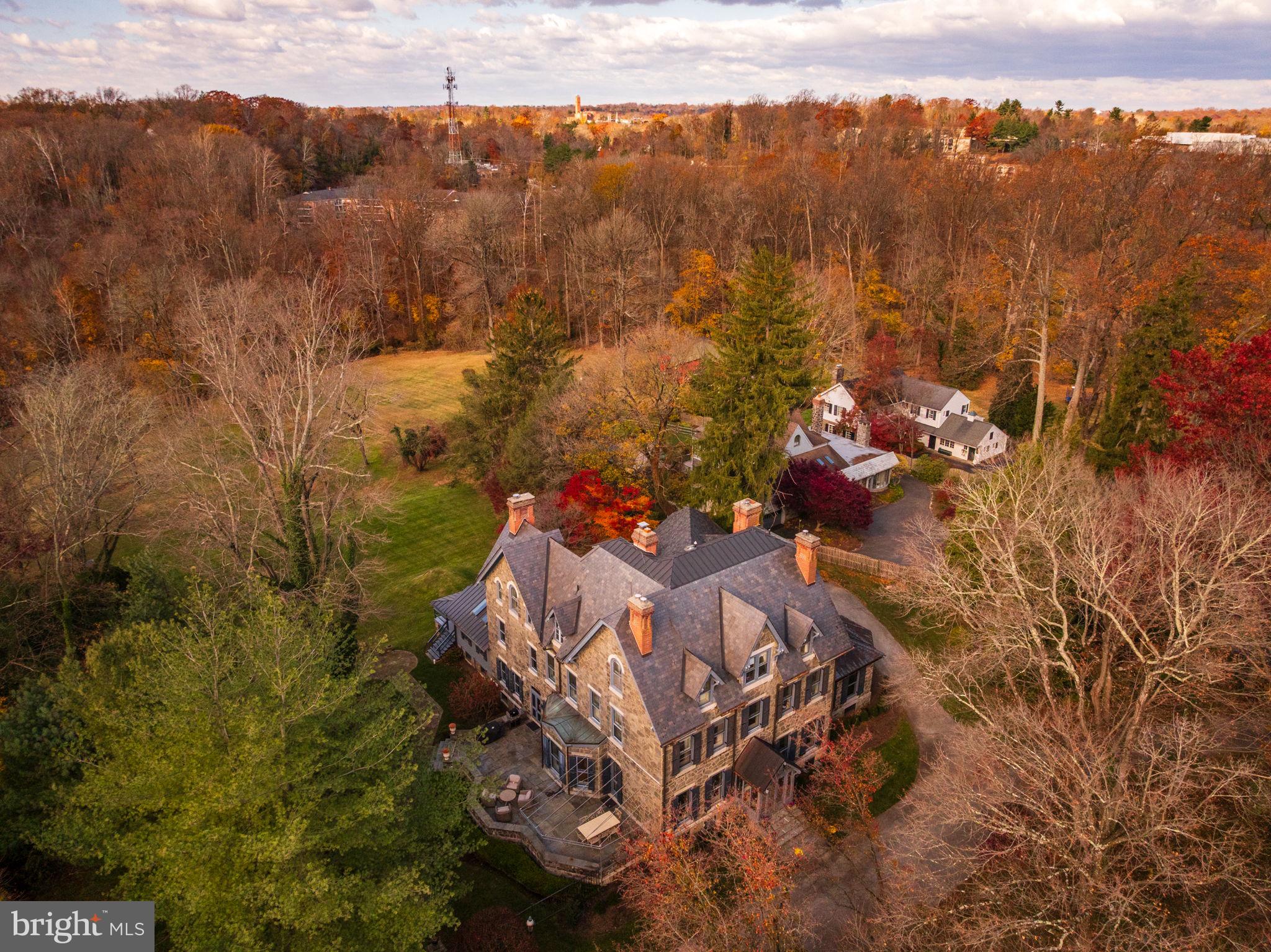Rarely does a historic Main Line estate combine architectural pedigree, privacy, and refined modern
living as seamlessly as this extraordinary Villanova property. Originally built in 1880 and later
reimagined by renowned architect John Milner, “Willow Creek” is a character-filled residence that blends
historic craftsmanship with thoughtful modern refinement. In recent years the home underwent a
comprehensive renovation, where every system, finish, and architectural detail was carefully restored or
rebuilt with exceptional attention to quality. Set on nearly four private, park-like acres with direct access
to the scenic Radnor Trail, the property offers a rare sense of serenity and space while remaining
moments from the heart of the Main Line. Craftsmanship takes center stage across 7,353 square feet of
finished living space with soaring 10-foot ceilings. Magnificent millwork, beautifully proportioned
rooms, and six original fireplaces create an atmosphere of timeless sophistication. A classic
slate roof further underscores the property’s architectural integrity and the sense that this is a home built
to last for generations. The experience begins at the circular drive, leading to an elegant entrance where
intricate leaded-glass mahogany doors open into a grand foyer with a sweeping staircase and soaring
ceilings. Architectural details abound, from coffered ceilings and deep-set windows.The main floor offers
a refreshed color palette, using light, modern hues that make the home feel bright and inviting. Just
through the family room and butlers pantry/bar area, at the heart of the home is the chef’s kitchen,
featuring custom cabinetry, a La Cornue range, and Sub-Zero refrigeration, supported by an impressive
Butler’s Pantry. This space flows seamlessly into a vaulted Sunroom with dining space with a fabulous
view to the back yard, exposed beams and skylights opening to a back porch with incredible views.
Whether elegantly entertaining in the formal living and dining rooms, working in the incredible
wainscoted office or enjoying a quiet morning or evening in the sunroom, the home adapts
effortlessly. Front and back staircases lead to the upper levels where the home offers six bedrooms, five
full baths and two half-bathrooms. The primary level includes two spacious primary-quality bedroom
suites, each with its own fireplace and beautifully appointed marble bathrooms. One suite features a
soaking tub, walk-in shower, and dual vanities, while the second suite offers another elegant bath with
soaking tub and shower. A third full bedroom on this level provides additional flexibility for families. A
laundry room and powder room complete this floor.The third level offers two additional ensuite
bedrooms, one of which includes a connecting sitting room, along with another bedroom served by a hall
full bath. A large cedar closet provides excellent storage, ensuring the home remains as practical as it is
refined.Beyond the interiors lies an unexpected treasure: an enormous, private backyard with mature
landscaping and sweeping views—a rare feature in such a prime location. Various porches and patios are
perfect for al fresco dining and relaxation, while access to the Radnor Trail makes weekend walks
effortless. A detached three-car garage with a second level already plumbed for a bath offers exceptional
potential for a guest suite, studio, or additional living space. The location is truly exceptional, offering
unparalleled convenience alongside top-ranked Radnor schools. Just moments from the SEPTA Regional
Rail and with easy access to Amtrak, travel to Center City, New York City, or Washington, DC is
remarkably effortless. Residents will enjoy close proximity to Villanova and Wayne’s vibrant shopping
and dining scenes, featuring boutique shops, cafés, and top-rated restaurants. This is Main Line living at
its finest-historic character, urban-inspired sophistication, luxury updates, and generous outdoor space.