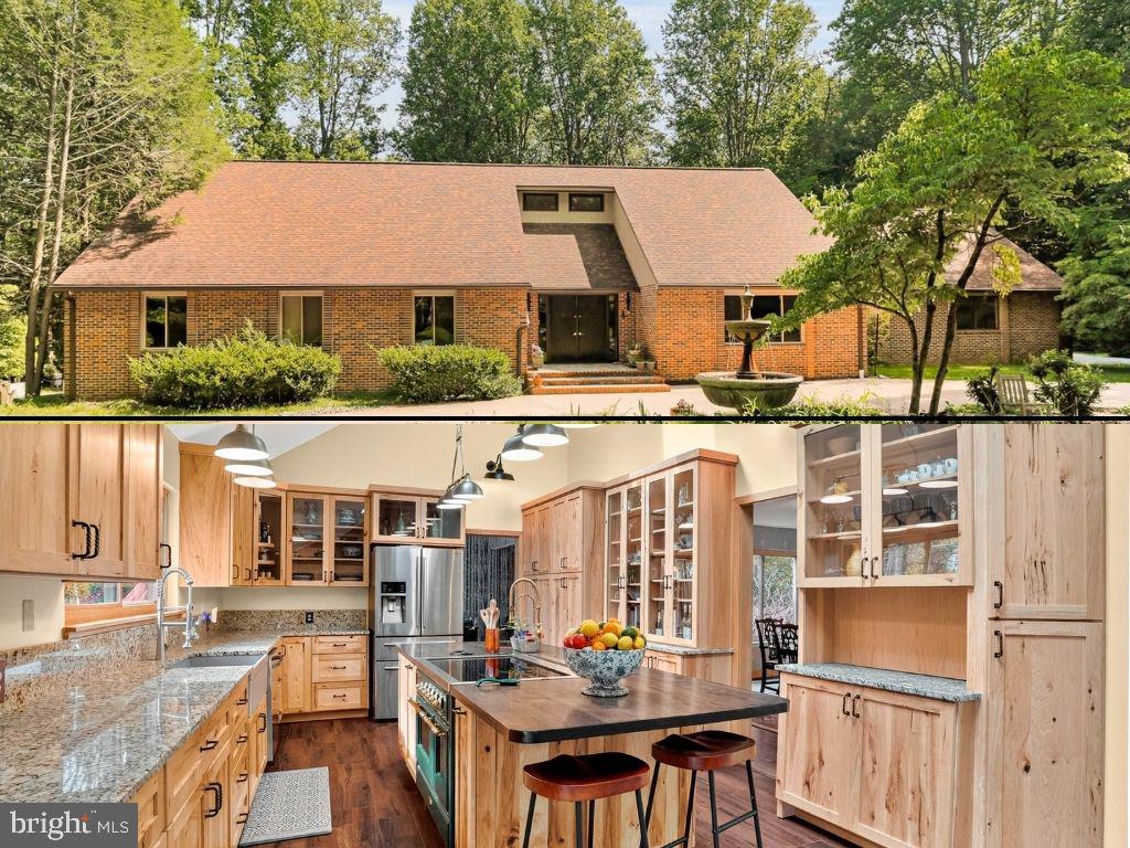 Welcome to this stunning architect-designed contemporary home offering 6 spacious bedrooms and 3.5 bathrooms, blending modern rustic style with warm, inviting design elements throughout. Nestled in a serene, private setting surrounded by lush nature, this peaceful retreat provides the perfect escape while still offering exceptional functionality for everyday living.

As you step inside, you’re greeted by wall-to-wall hickory floors beautifully punctuated by ceramic accents, stunning exposed brick features, and thoughtfully curated finishes that create a warm yet sophisticated atmosphere. The exposed brick walls and accents throughout the home add character, texture, and timeless charm, perfectly complementing the home’s modern rustic aesthetic. Charming wallpaper accents and natural materials further enhance the inviting architectural design.

The heart of the home is the gourmet kitchen, featuring an ILVE induction stove, mixed metals, a striking gray farmhouse sink, luxurious granite countertops, a custom hickory ridge countertop, and a copper sink. Stunning Amish-crafted hickory cabinetry adds warmth and craftsmanship to the space. The lower-level kitchen is equally impressive with a convection oven, refrigerator, dishwasher (only 3 years old), quartz sink, butcher block countertops, and disposal—ideal for entertaining or multigenerational living.

Retreat to the luxurious primary suite and spa-inspired bath complete with a Japanese-style soaking tub, walk-in shower, double sinks with LED-lit mirrored cabinets, rich ceramic and marble walls, and elegant waterfall glass sinks. The hall bath offers natural stone flooring, a standalone 6-foot tub, and Mediterranean-inspired stone pebble finishes, while the downstairs full bath features modern fixtures, an LED mirror, and charming barn-style touches.

Outside, the beautifully landscaped front patio lined with slate and brick creates a welcoming first impression, while the terracotta concrete driveway adds Tuscan-inspired charm and provides parking for up to 10 vehicles. The expansive rear balcony and deck stretch across much of the home, overlooking a stunning kidney-shaped heated saltwater pool—perfect for relaxing or entertaining.

Modern conveniences include a propane generator, energy-efficient solar panel system, and multiple ductless multi-unit systems for year-round comfort. Recent updates include a new roof and windows installed in 2015, along with fresh paint throughout. Thoughtful landscaping, including beautiful dogwood trees, completes the setting.

This one-of-a-kind residence offers the perfect blend of luxury, rustic-modern style, comfort, and tranquility—truly an exceptional place to call home.