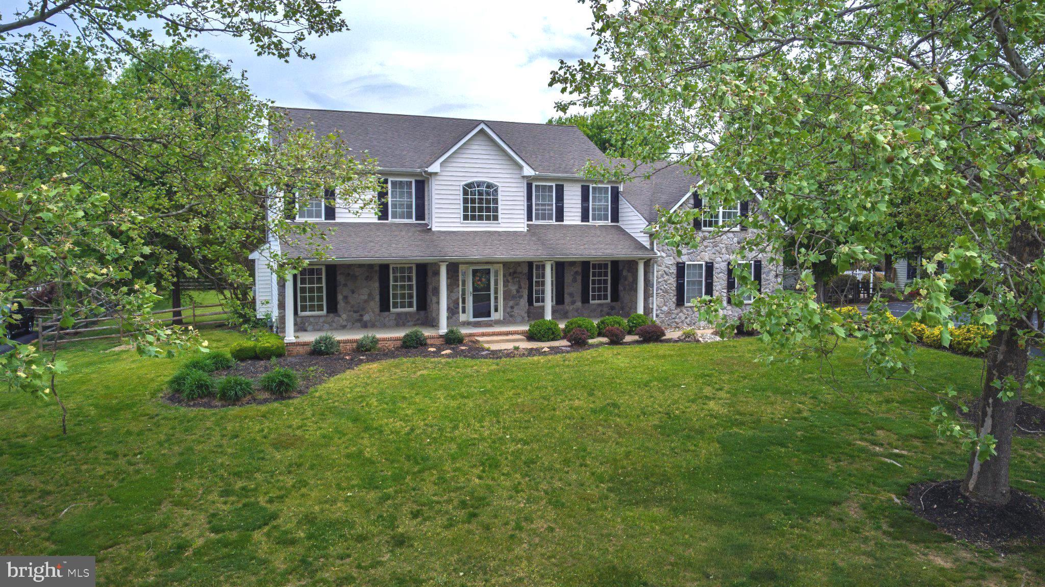 Deep price reduction! Schedule a tour today to see this stunning executive home located in sought-after Westside Hunt and the Appoquinimink School District offers casual elegance, almost 5000 square feet of living space, and solid craftsmanship by Desabatino Construction. This home features a beautiful stone facade, gracious covered porch for morning coffee or relaxing afternoons, gleaming hardwood floors, 9' first floor ceilings, an ample family room with cozy gas fireplace adjoining the generous kitchen with center island, great pantry, newer stainless steel appliances, and a sunlit breakfast alcove overlooking the large deck and the expansive, fully fenced back yard. The two story foyer with handsome oak staircase takes you to the second floor where you'll find four comfortable bedrooms, three full baths, and a spacious 20 x 24 bonus room or 5th bedroom . The primary retreat offers a luxurious en-suite bath with huge soaking tub, walk-in shower and double vanity. The fourth bedroom/guest suite is complete with a private full bath and jetted tub.  The massive finished lower level with built-in bar is the perfect entertainment, media/game room, work or hobby space.  The two car garage is equipped with a plug for your EV charger and leads to a handy mudroom/drop zone for shoes and gear.  Other features include a new water heater, new carpet, and newer HVAC. Nestled on .8 acres and conveniently located in peaceful and picturesque West Middletown this home offers easy access to restaurants, shopping, schools, marinas, YMCA, parks and outdoor recreation as well as the Rt. 301 bypass and Rt. 1 for a quick commute to points North and South.
