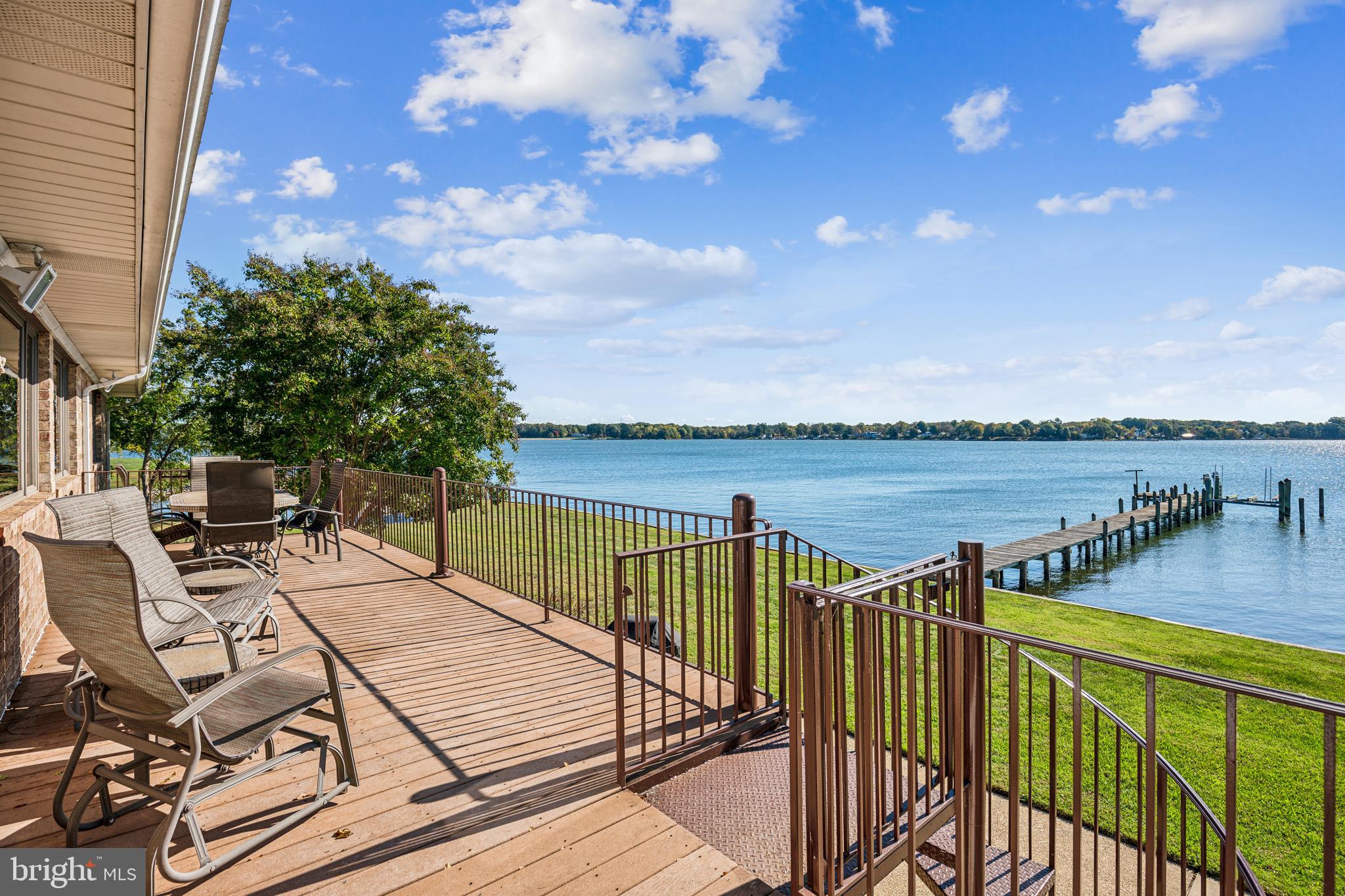 Thrilled to share this beautiful waterfront home positioned off St. Clement’s Bay!  This home located at 22465 Ellis Road is a charming one-level brick rambler on a full basement offering breathtaking views of Saint Clement's Bay from almost every room. Situated on a peninsula at the end of a county and private road, this home boasts approximately 340 feet of water frontage, providing a serene and private setting with wide-open bay views.  Key features are 4 bedrooms with attached full baths for each, and 3 half baths placed conveniently throughout the home for guests. Enjoy spacious living areas, including a large primary suite with water views, a recently remodeled ensuite with a deep jacuzzi tub, stall shower, and double vanity.  Living spaces - the expansive living room features hardwood floors, a wood-burning stacked stone fireplace, and access to a sunroom that captures stunning bay views. The dining room, with ample space for a long dining table, also overlooks the water.  Updated Kitchen. - the kitchen is beautifully updated with granite countertops, stainless steel appliances, a large island with a prep sink, and propane/gas cooking stations set in elegant brick alcoves. You’ll love the picturesque water view from the kitchen sink. Lower level entertainment - the lower level includes a billiard room with a second brick wood-burning fireplace, a wet bar, as well as windows offering bay views. It opens to an indoor and outdoor patio with access to the pier. 
 Outdoor features - the home’s outdoor space includes a large deck, a freestanding gazebo, and a fire pit, perfect for relaxing or entertaining while soaking in the panoramic water views. The pier, equipped with a boat lift and utilities, offers deep water (approx. 10’ MLW) for boating enthusiasts. The replaced sea wall (2016) adds extra protection to the waterfront.  Landscaping and additional amenities - the professionally landscaped yard was enhanced in 2016 and offers a serene and inviting environment, complemented by a paved driveway and a two-car attached garage. Utilities and systems - the home operates on oil-fired baseboard hot water heating, central air conditioning, a private well, and a gravity-based septic system. Additional systems include a generator (for select circuits), a whole-house vacuum system, and the property has been wired for high-speed connectivity and telephone landline service.