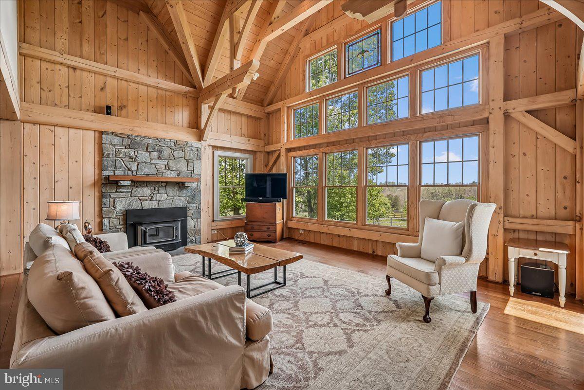 Tired of touring the same predictable floor plans? This one is anything but ordinary.

Custom built by a respected local craftsman as his personal residence, this remarkable post-and-beam home offers the warmth of a mountain lodge paired with the comfort and functionality today's buyers expect. Nestled on a private 1.36-acre cul-de-sac homesite backing to nature, the property delivers a peaceful retreat just minutes from everyday conveniences.

Inside, over 3,800 finished square feet showcase authentic timber-frame construction, soaring ceilings, exposed wood walls, and a stunning wall of windows that fills the home with natural light while framing beautiful wooded views. The open-concept design creates an inviting atmosphere ideal for both everyday living and entertaining.

The main-level primary suite offers convenience and privacy, while four generously sized upper-level bedrooms provide flexibility for family, guests, hobbies, or home office needs. One bedroom features a charming hidden loft, while the oversized bonus room can easily serve as a recreation room, studio, playroom, or additional gathering space.

Distinctive details throughout include a dramatic stone fireplace, stylish farmhouse-inspired kitchen, screened morning room, open catwalk overlooking the great room, oversized 2.5-car garage, cedar siding, and a full walk-out basement ready for future expansion. Rich in character, craftsmanship, and architectural detail, this is a rare opportunity to own a truly one-of-a-kind home designed to stand apart from the ordinary.