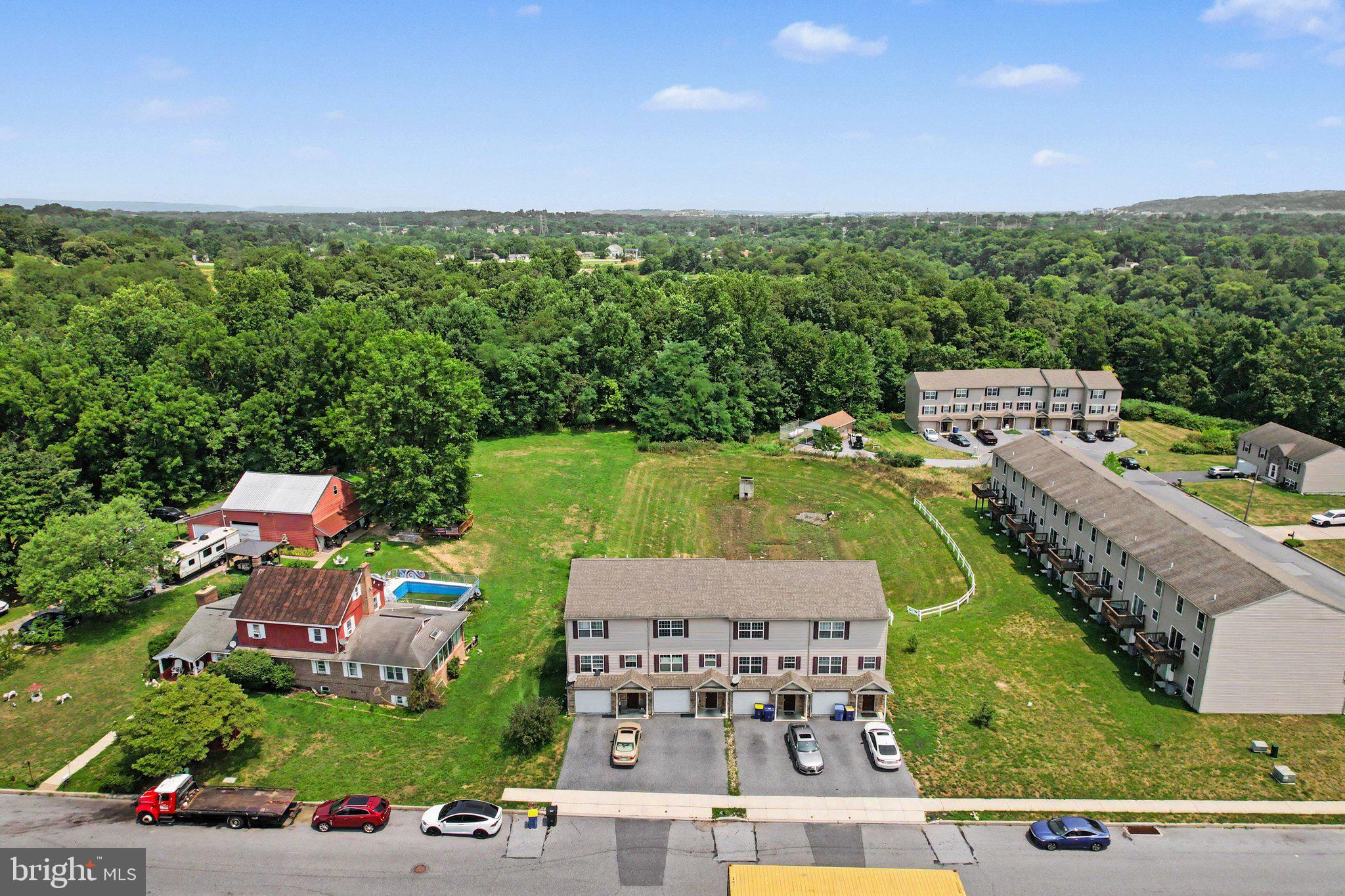Discover a prime investment opportunity  with 12 townhomes built in 2018 in The Woodlands townhome cummunity  This community is close to both Harrisburg and Hershey.  All 12 units are leased.  4 units on 82nd St all have 2 bedrooms and 1 1/2 bathrooms and currently rent for $1,650. 8 units on Greg Dr all have 2 bedrooms and 2 full bathrooms and rent for $1,800.  See associated documents for profit and loss.  Spanning 0.83 acres, this property features durable vinyl siding and offers ample parking with both surface and 1 car garage for each unit.  The strategic location within a growing community enhances its appeal, making it an ideal choice for investors seeking steady rental income or future appreciation. Don't miss out on this chance to secure a valuable asset in a desirable area. Act now to capitalize on the growth potential!