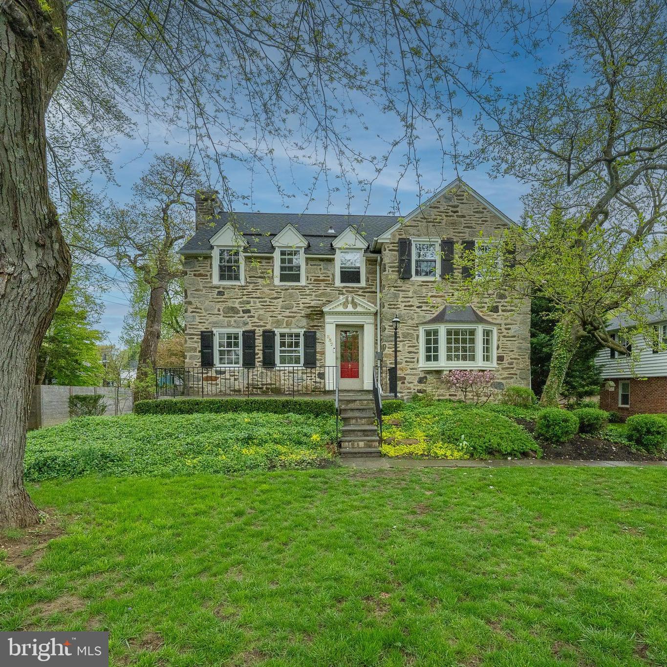 Welcome to this beautifully updated 4-bedroom, 3.5-bathroom center hall Colonial, nestled on a serene street in the heart of Wynnewood. With 4,189 square feet of elegant living space and exceptional attention to detail, this home offers the perfect blend of timeless charm and modern updates. Step onto the inviting slate front porch and into a gracious formal living room featuring rich hardwood floors, crown molding, chair rail, and a cozy wood-burning fireplace. French doors lead to a sun-drenched year-round sunroom with skylight and scenic views of the private, fenced backyard. The formal dining room is bright and welcoming, enhanced by a bay window, crown molding, and chair rail—perfect for hosting gatherings. The updated, eat-in chef’s kitchen is a dream, boasting granite countertops, stainless steel appliances, a central island, abundant cabinet space, and a built-in desk nook. Off the kitchen, a spacious mudroom with custom built-ins, a convenient half bath, and access to a large Trex deck provides seamless indoor-outdoor living. Upstairs, the expansive primary suite features two closets and a beautifully renovated en-suite bath with a marble double vanity and an oversized walk-in shower. Two additional bedrooms share a stylish Jack-and-Jill bathroom with a tub, while a fourth bedroom, hallway laundry, and a linen closet complete the second floor. The finished walk-out lower level offers bright, flexible space ideal for a family room or playroom, complete with an updated full bath with walk-in rain shower, utility room, and ample storage. Additional highlights include a freshly painted interior and exterior (2025), all-new carpet, a two-car garage, a long private driveway, and mature landscaping. An outdoor EV charging plug adds modern convenience. Located in the award-winning Lower Merion School District and just minutes from the shops and restaurants of Narberth and Ardmore. This exceptional home truly has it all—space, style, and location!