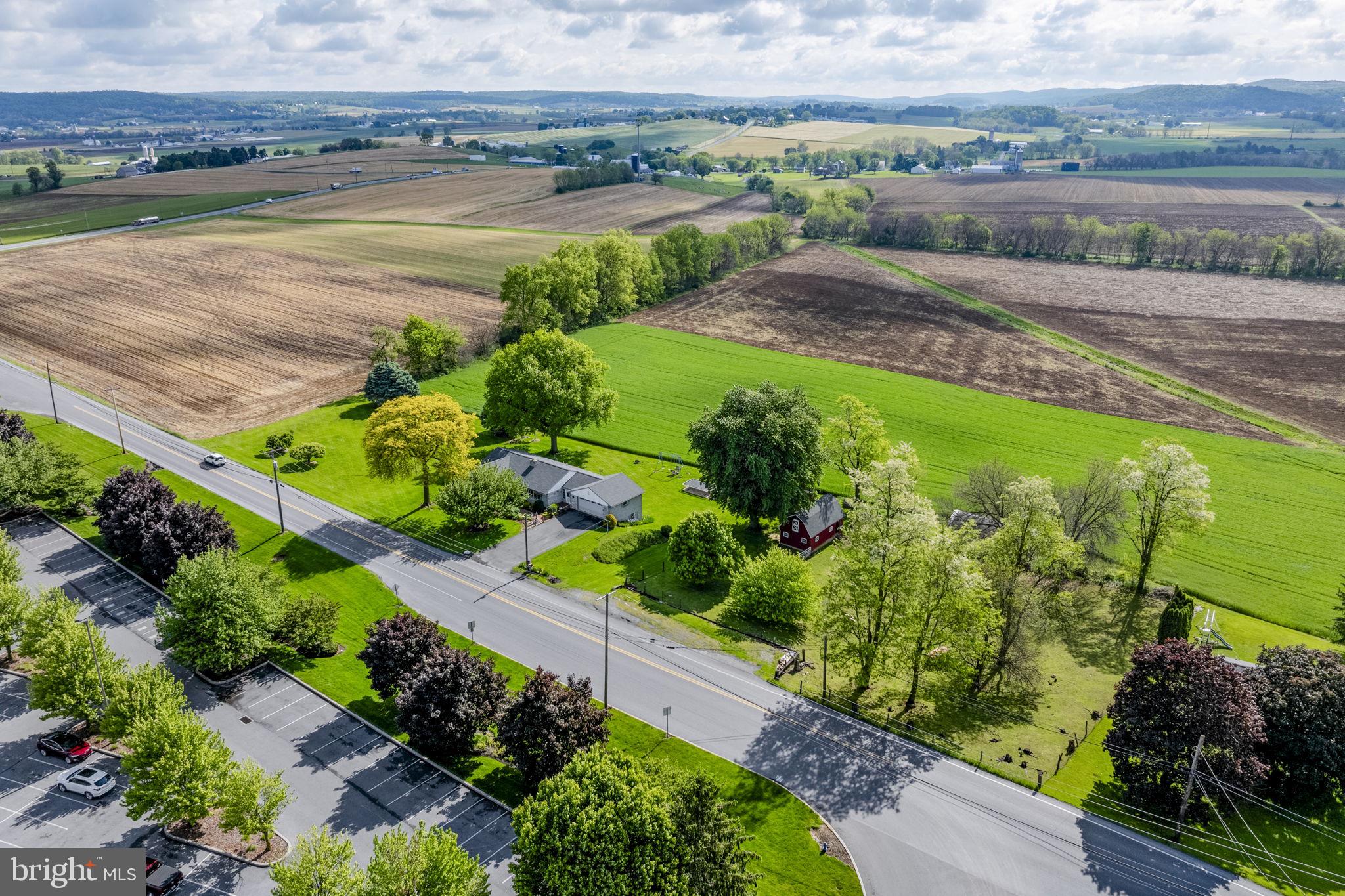 AUCTION DATE - THURSDAY, JULY 23, 2026 AT 1PM. LISTED PRICE IS AN OPENING BID ONLY AND IS NOT INDICATIVE OF THE FINAL SALE PRICE. REAL ESTATE:  1 sty. Holland stone one owner rancher w/2890 SF finished area w/eat-in kitchen w/cherry raised panel cabinets, pantry, appliances & dining area, living rm. w/bow window, 1st floor laundry/mudroom, 3 bdrms., 2 full baths, attic, daylight bsmt. w/finished spacious family rm. w/fireplace, office, canning rm., built-in 1 car gar./shop, heat pump, central AC, enclosed breezeway, rear deck, patio & attached 2 car garage. Outbldgs.: 2 sty. frame hip roof barn 28×16 w/sheep pen & fenced pasture & utility bldg. 20×12 all on 1.72 ACRES country lot w/farmland boundary, double width macadam driveway, lawn & garden area, mature shade, professional landscaping, on-site well & septic. Two separate deeded tracts all sold as one property. Zoned Ag. NOTE: Owner relocated to retirement quarters! Ideally located country property w/solid built & well maintained one owner rancher built by John Weber Builders. Minutes to Rts. 322, 23, 897 & 625. Terms 10% down, balance 60 days or before. Personal inspection by appointment or open house Sat., July 4, 11 & 18 from 1 to 4 PM.
