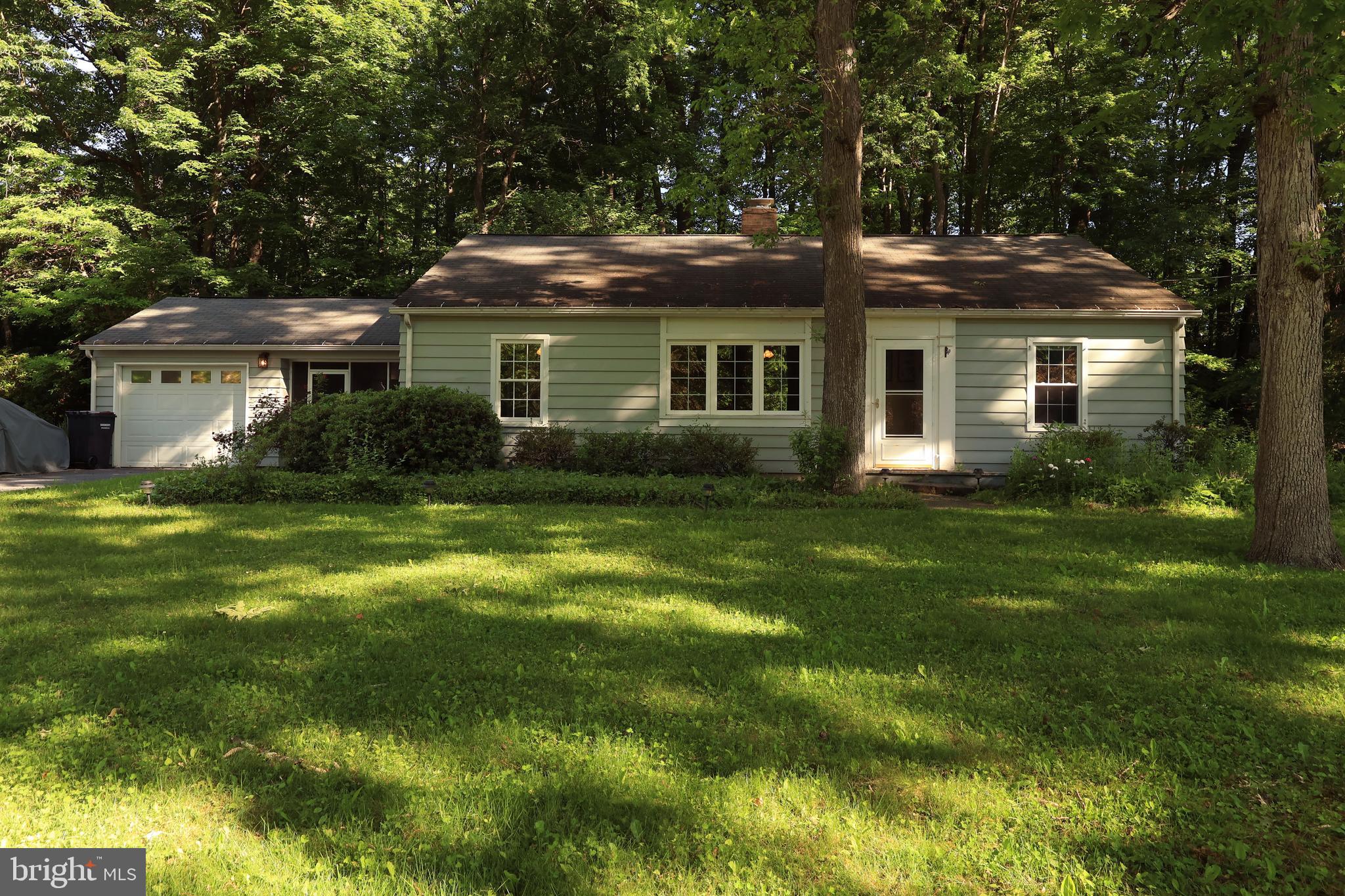 Nestled on a picturesque .49-acre tree-lined lot in the highly desirable Park Forest Village neighborhood, this well-maintained ranch offers the convenience of seamless single-level living in a location that places shopping, dining, parks, schools & Penn State University just minutes away.  Step inside to discover a spacious living room filled with natural light, beautiful hardwood flooring & a stunning double-sided brick wood-burning fireplace that serves as a warm focal point between the living & dining areas. Whether hosting gatherings or enjoying a quiet evening at home, this inviting space is designed for comfortable everyday living.  The updated kitchen is both functional & stylish, featuring solid wood cabinetry, solid-surface countertops, abundant storage, generous workspace for meal preparation & included appliances. The adjoining dining area offers the perfect setting for family dinners & entertaining guests.  The primary bedroom features a private full bath, while two additional bedrooms & a second full bathroom provide comfortable accommodations for family & visitors. A convenient main-level laundry room further enhances the ease & practicality of one-floor living.  One of the home's standout features is the screened breezeway, offering a peaceful retreat to enjoy your morning coffee, unwind after a long day, or simply take in the beauty of the surrounding landscape. Step outside to the rear concrete patio overlooking the serene tree-lined backyard, creating an ideal setting for outdoor dining, relaxation & summertime gatherings.  Adding even more value & peace of mind, a brand-new HVAC system will be installed July 2026, ensuring year-round comfort for the next owner.  Currently tenant occupied through the end of July, this property presents an excellent opportunity to secure a home in one of State College's most sought-after neighborhoods while planning for future occupancy. Combining a desirable location, thoughtful updates, inviting indoor & outdoor living spaces, and the tranquility of a beautiful, wooded setting, this charming Park Forest ranch is ready to welcome you home.