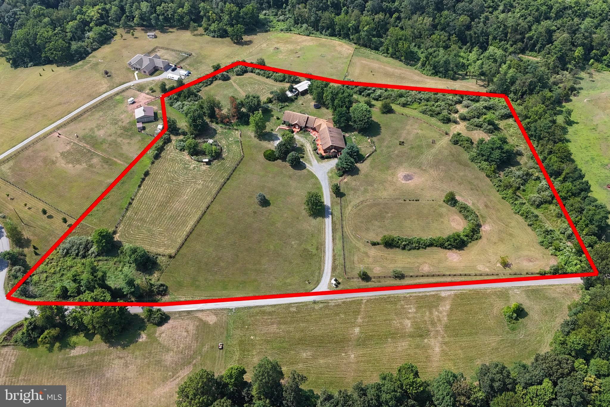 SEE VIDEO TOUR & FLOOR PLANS TO FULLY UNDERSTAND WHAT THIS PROPERTY OFFERS!!! Talk about unlimited potential!  Over 6,200 square feet with 9 bedrooms, 5 full bathrooms and 7 half bathrooms on 10 UNRESTRICTED acres with gorgeous mountain views and equestrian amenities.  Currently being used as an assisted living facility with 5 private rooms, large great/gathering room, commercial kitchen, loft office and adjacent owner’s residence with 2 additional lofts.  Potential uses include continuing as an assisted living/memory care facility, multi-room Airbnb/lodge, retreat center, event center, equestrian themed getaway, family compound or whatever you choose.  The great room and owner’s residence features beautiful stained knotty pine walls and vaulted ceilings, curved oak stairs, oak cabinetry, luxury vinyl plank flooring and exposed ceiling beams.  Priced at just $116/SF and on 10 acres, you WILL NOT find a property offering the diversity of this one!