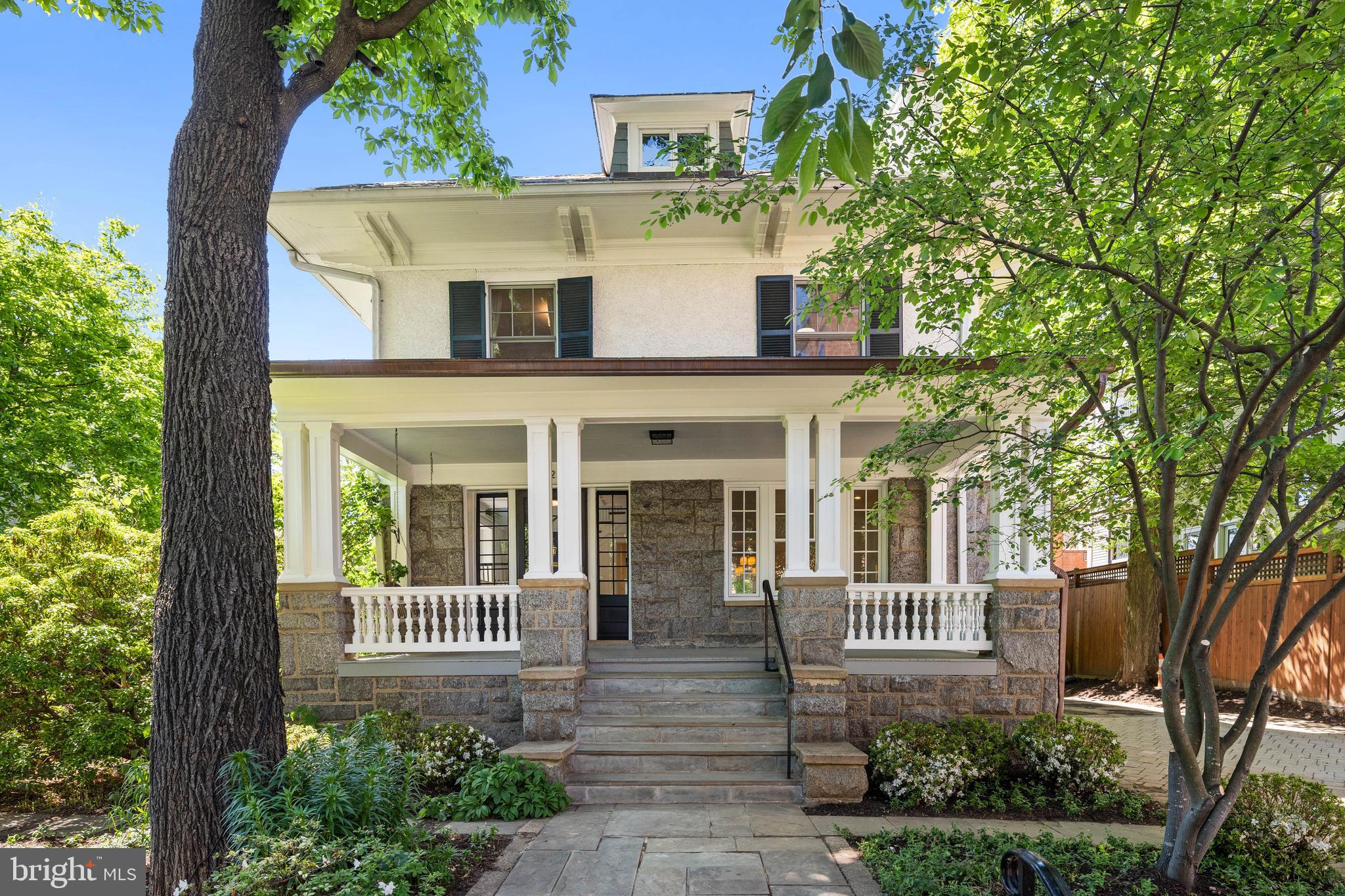 Well sited on one of Cleveland Park’s most established and picturesque blocks, with views of the Washington National Cathedral, this residence offers a balance of historical architectural details, and a modern floor plan with recent renovations and updates throughout. 
A classic front porch with a swing, sets is both inviting and quietly elegant. Inside, a gracious foyer unfolds into a sequence of beautifully proportioned spaces: an elegant formal living room with a fireplace, a spacious dining room designed for both intimate evenings and larger gatherings, and a casual family room.
The generous and thoughtfully designed kitchen overlooks the richly landscaped rear yard. Kitchen features a Wolf range, Sub-Zero refrigeration, a pantry, and ample cabinetry, A side-entry mudroom provides seamless access to the expansive rear yard and front parking area. Additionally, there is a powder room discretely located in the hall.  
The second level is generous and offers two comfortable bedrooms, a hall bath, and an expansive primary suite. The primary offers a true sense of retreat with a spa-like bath, walk-in closet, and a private deck with striking National Cathedral views. Additionally, there is a dedicated laundry area on this floor.  
The top level offers two additional bedrooms, a newly renovated hall bath, and abundant storage. 
The lower level is fully self-contained and thoughtfully executed, featuring a spacious living area, bedroom, bath, kitchen, washer and dryer, and a fitness area. With its own private entrance leading directly to the rear garden, it is ideally suited for an au pair, guests, or long-term stays.
The light-filled residence has been beautifully updated and offers a renewed sense of style and craftsmanship. Both the front and rear landscaping have been expertly designed, creating a setting that feels established, private, and quietly luxurious.
The residence is ideally positioned near the shops and restaurants along Wisconsin Avenue NW and Cathedral Commons, the location also benefits from close proximity to City Ridge, a newer luxury destination offering premier fitness, dining, and daily conveniences. Access to highly regarded schools such as National Cathedral School, St. Albans School, Beauvoir, The National Cathedral Elementary School, Sidwell Friends School, and John Eaton Elementary School further enhance its appeal.
This is a residence that embodies the enduring character of Cleveland Park, elevated through thoughtful design, updates, and landscaped gardens.