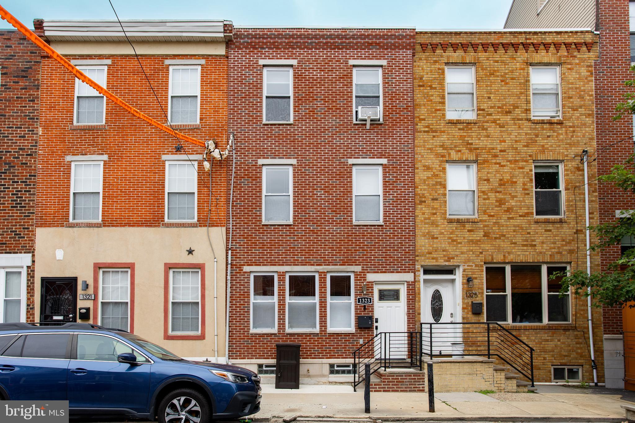 Welcome to 1323 S. 17th Street, a lovely 4-bedroom, 3-bathroom Philadelphia townhome offering updated finishes, comfortable living spaces, and great outdoor amenities. The home opens into a cozy living room with hardwood flooring, crown molding, and chair rail detailing. The adjoining dining room continues with hardwood floors, crown molding, and chair rail, creating a comfortable space for everyday meals or entertaining. Just beyond the dining area is a renovated kitchen with tile flooring, quartz countertops, crown molding, stainless steel appliances, a dishwasher, an electric oven, and a range hood. On the second floor, you’ll find two bedrooms with hardwood flooring, including one with an en-suite bathroom featuring tile flooring. A full hall bathroom with tile flooring and granite countertops serves this level. The top floor is home to the spacious primary bedroom, featuring hardwood floors, crown molding, a tray ceiling, ceiling fan, and a private en-suite bathroom with tile flooring, a shower, and single sink vanity. Just outside the primary bedroom, there is a walk-in closet. An additional bedroom with hardwood flooring completes the upper level, with a private balcony by the room that offers a great spot to enjoy fresh air. Out back, the patio provides outdoor space for relaxing or entertaining. Conveniently located near local restaurants, coffee shops, parks, public transportation, and everyday amenities, this home offers both a residential feel and accessibility. Don’t miss the opportunity to make 1323 S. 17th Street your next home!
