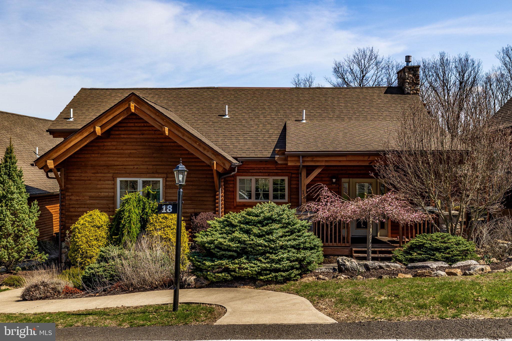 Beautiful ski in/out log cabin in Eagle Rock Resort. This meticulously maintained home features 3 bedrooms on the main and upper levels, plus 2 bonus rooms in the finished  lower level—perfect for guests. Ideally located near the main gate for easy access while sitting at the heart of the winter action, steps from the slopes. Negotiable furniture offers a turnkey resort lifestyle.

The log cabin welcomes you with soaring vaulted ceilings and a magnificent floor-to-ceiling stone fireplace that radiates rustic warmth. Rare and highly desirable, the main level features two spacious bedrooms, each with its own private bathroom, providing a level of privacy and accessibility that is a standout feature of this property. The open-concept kitchen and dining area are designed for seamless entertaining, embodying the very best of luxury mountain living.
The upper-level loft provides a stunning overlook of the great room and offers flexible space for an office or additional sleeping quarters. For even more room, the fully finished lower level serves as a complete secondary living suite for guests. It features a large recreation/family room equipped with a wet bar and an additional bathroom, giving your guests their own private floor to unwind and socialize.
As an owner at Eagle Rock Resort, you'll enjoy exclusive access to these amenities:

Golfing: 18-hole Arnold Palmer-designed course and a 9-hole Executive course.

Pools & Aquatics: 3 outdoor pools plus an Aquatic Center featuring 3 additional pools and a hot tub.

Lake Life: Private beach area with paddle boats, BBQ grills, and picnic tables.

Winter Sports: On-site skiing and snow tubing.

Sports Courts: Tennis, Pickleball, Volleyball, Bocce, and Cornhole.

Equestrian Center: Horseback riding and boarding available.

Health & Wellness: Full-service Spa, Gym, and Sauna.

Dining & Social: Clubhouse with on-site restaurant and bar with a year-round social events calendar.

An additional fee of $1,200 for council dues that cover maintenance, landscaping, and repairs billed semi-annually.

All measurements and floor plans are estimates.

Don't miss this rare opportunity to own a slope-side log cabin masterpiece. Schedule your private tour today!