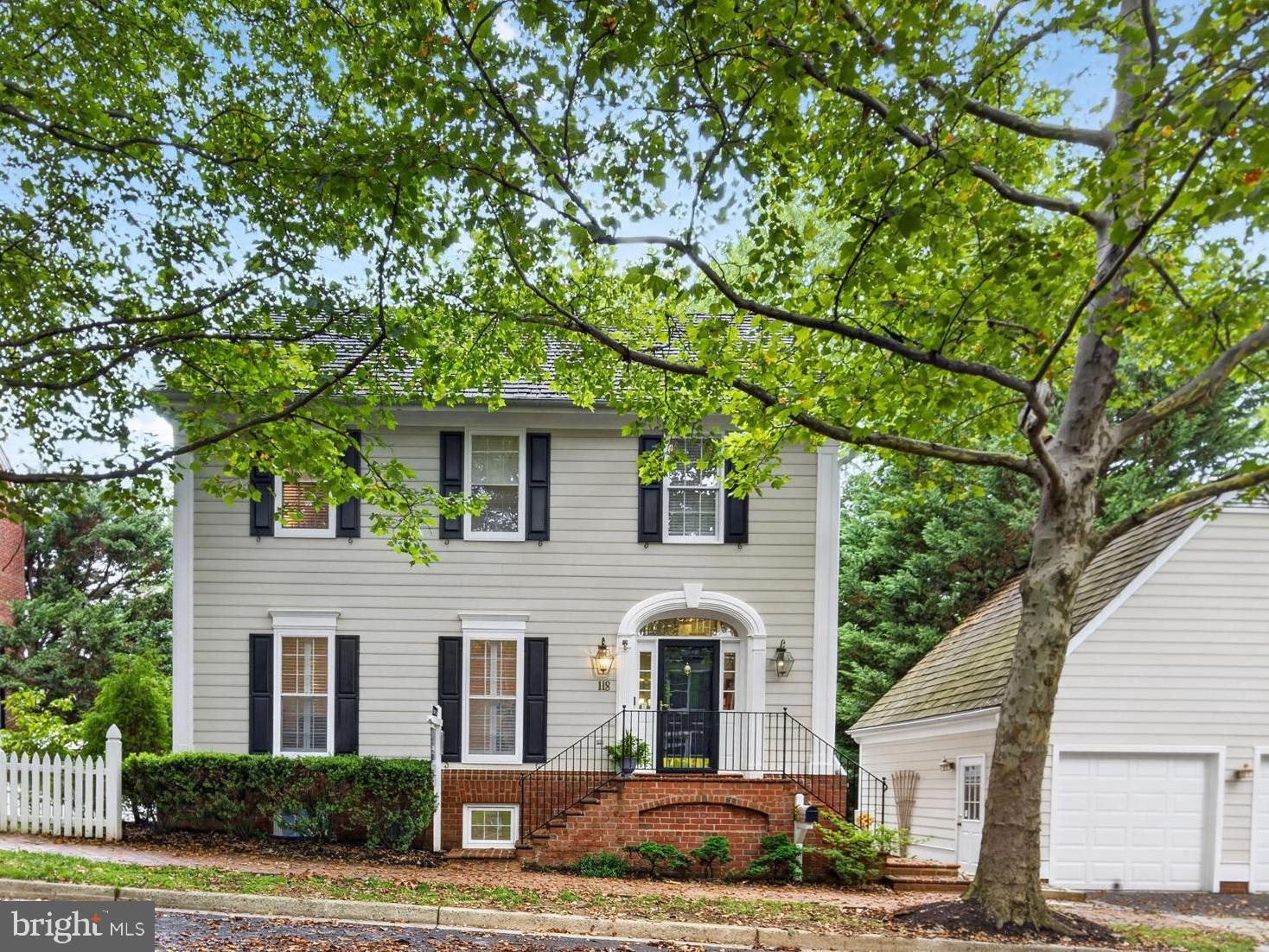 Tucked along one of Kentlands' iconic tree-lined streets, this stunning home delivers the quintessential Kentlands lifestyle — serene natural surroundings, an unbeatable location, and timeless charm. 
Backing to lush trees with tranquil views of Lake Helene, it's a rare find that places you just steps from everything the neighborhood has to offer.
Across three thoughtfully designed levels and approximately 4,080 square feet, the home features 5 bedrooms and 3.5 baths. Crown molding elevates the spacious living room, while the dining room opens directly to a private deck. The cook's kitchen is anchored by a center island and connects seamlessly to the family room, where a wood-burning fireplace sets a warm and welcoming tone.
In the upper level you will find a generous primary suite with newly renovated en-suite bath, 3 additional bedrooms, full bath and laundry room.
The walk-out basement expands the living space considerably, offering a generous rec room, a fifth bedroom, a full bath, and flexible finished space ready to serve as a home office and/or fitness area.  
Outside, the large fenced-in yard provides a private outdoor retreat for play, pets, or gardening,.
 This home is positioned perfectly between Kentlands' vibrant shopping and dining district and the peaceful Mansion and lakes area, this home embodies the very best of walkable, small-town urban living.
