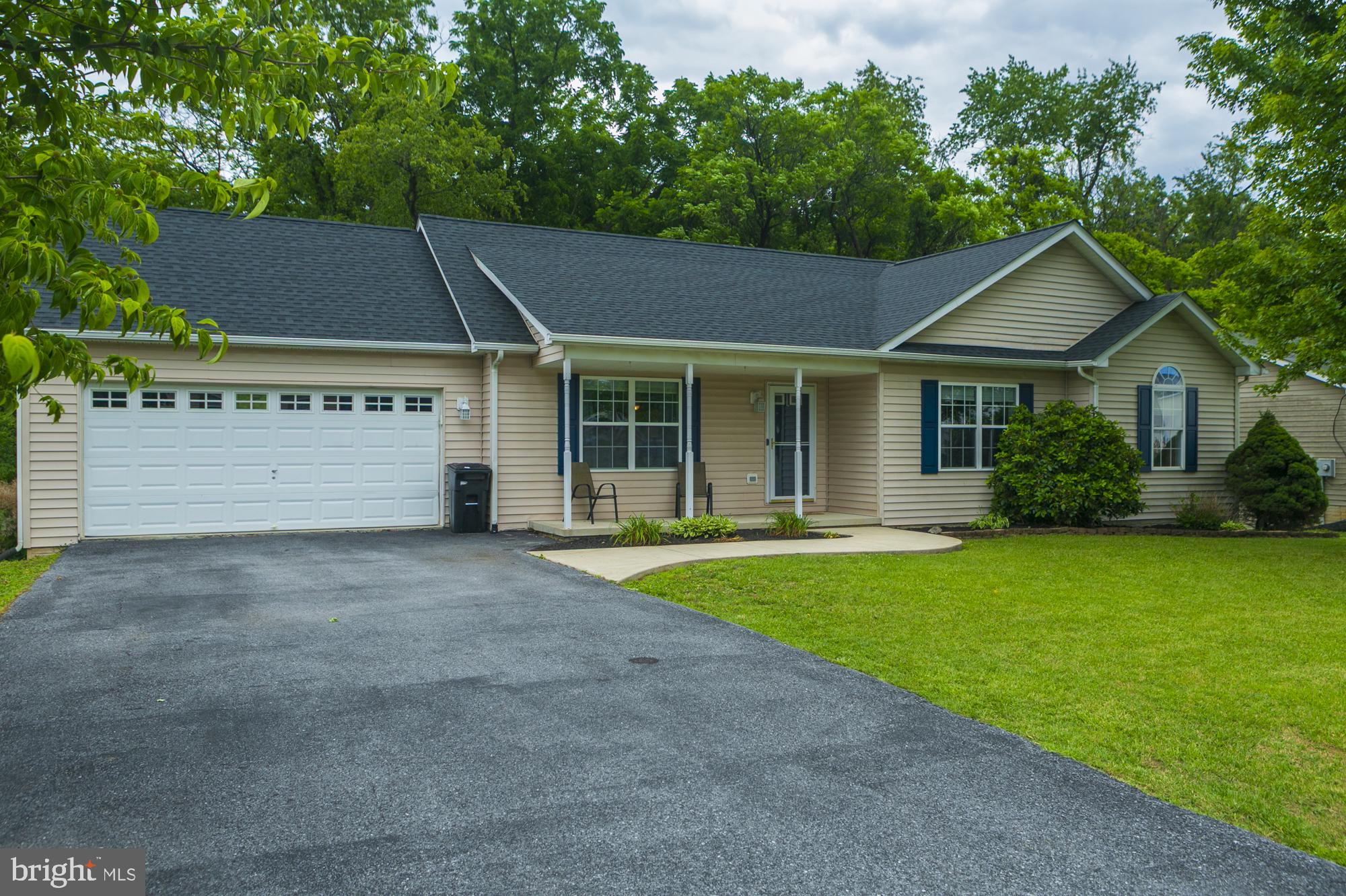 This charming ranch-style home in the desirable Ridgefield subdivision offers a spacious 3-bedroom, 3-bath layout with an estimated 2,356 sq ft of well-maintained living space. The interior features a traditional floor plan with an eat-in kitchen with dining area. Enjoy modern conveniences with a built-in microwave, dishwasher, and electric oven/range. The main level primary suite boasts a walk-in closet and a private bath. The mostly finished recreation room features a large area for a possible game room or in home theater with projector mount and screen conveying, a bathroom, storage room, utility room and walk out to the rear yard. Step outside to a beautifully landscaped lot of 0.19 acres, backing to serene trees for added privacy. The exterior includes an inviting front porch and a deck, perfect for outdoor entertaining. Parking is a breeze with a 2-car attached garage and ample driveway space. Located in a suburban setting, this home combines comfort and convenience, making it an ideal choice for those seeking a peaceful retreat with easy access to local amenities, commuter routes and medical offices. Don't miss the opportunity to make this property your own!